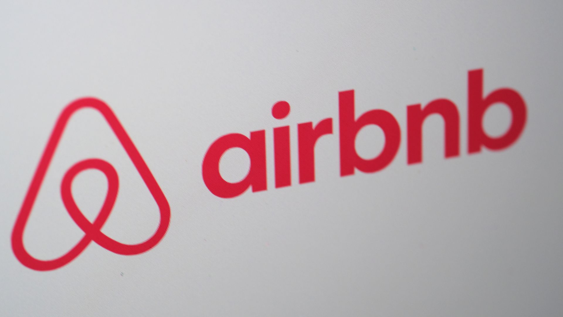 The airbnb logo on a screen