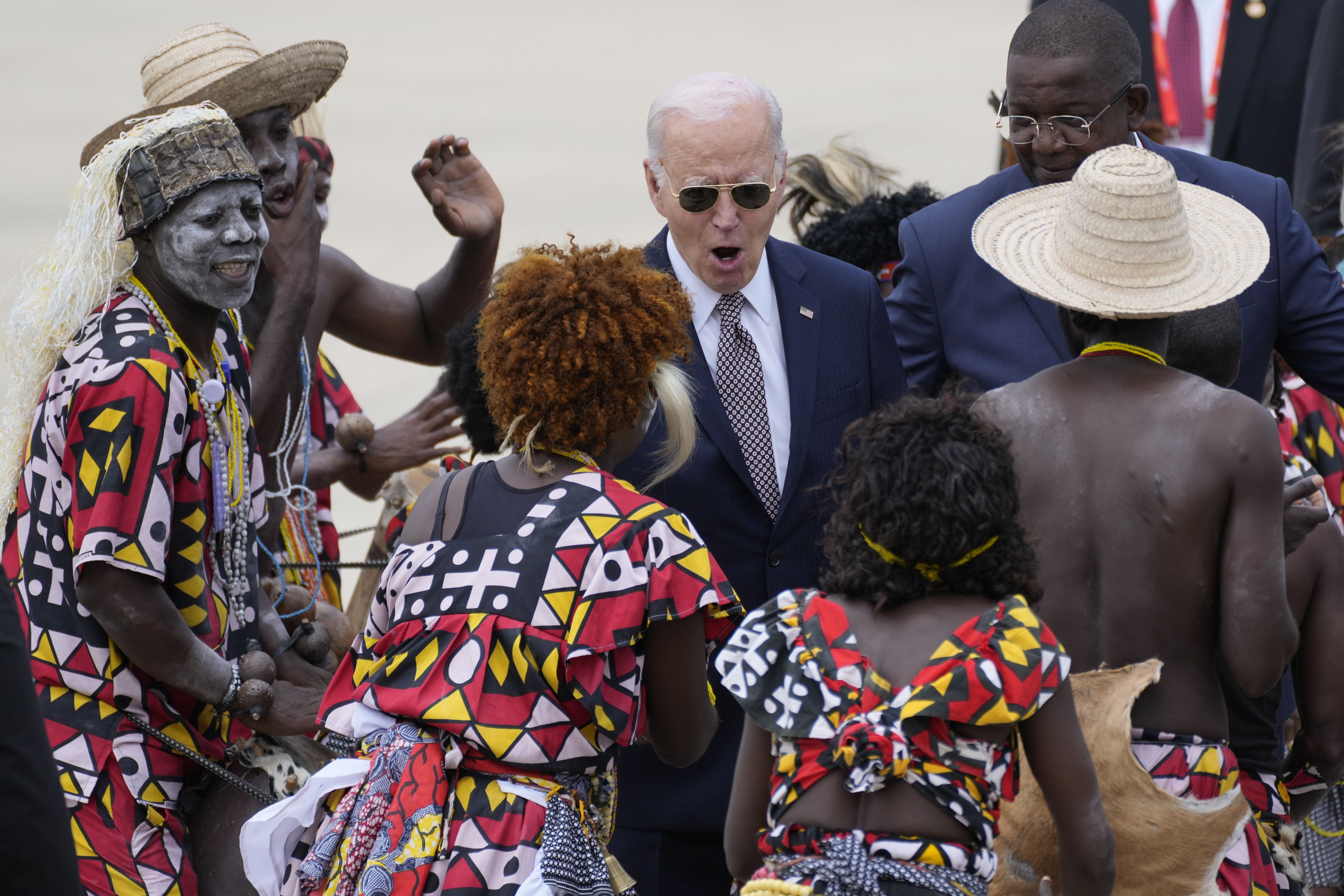 President Biden watches a traditional dance after arriving at Catumbela airport in Angola yesterday.