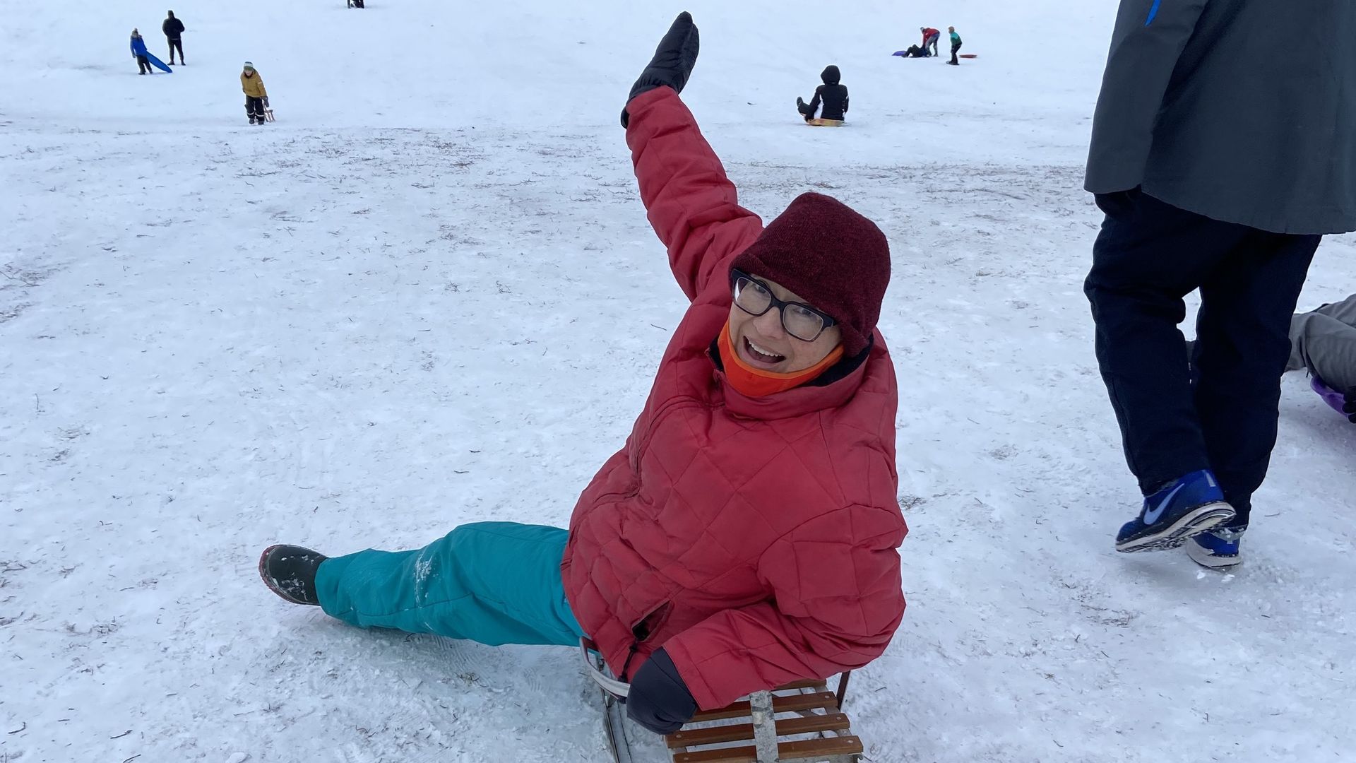 Photo of a woman on a sled.