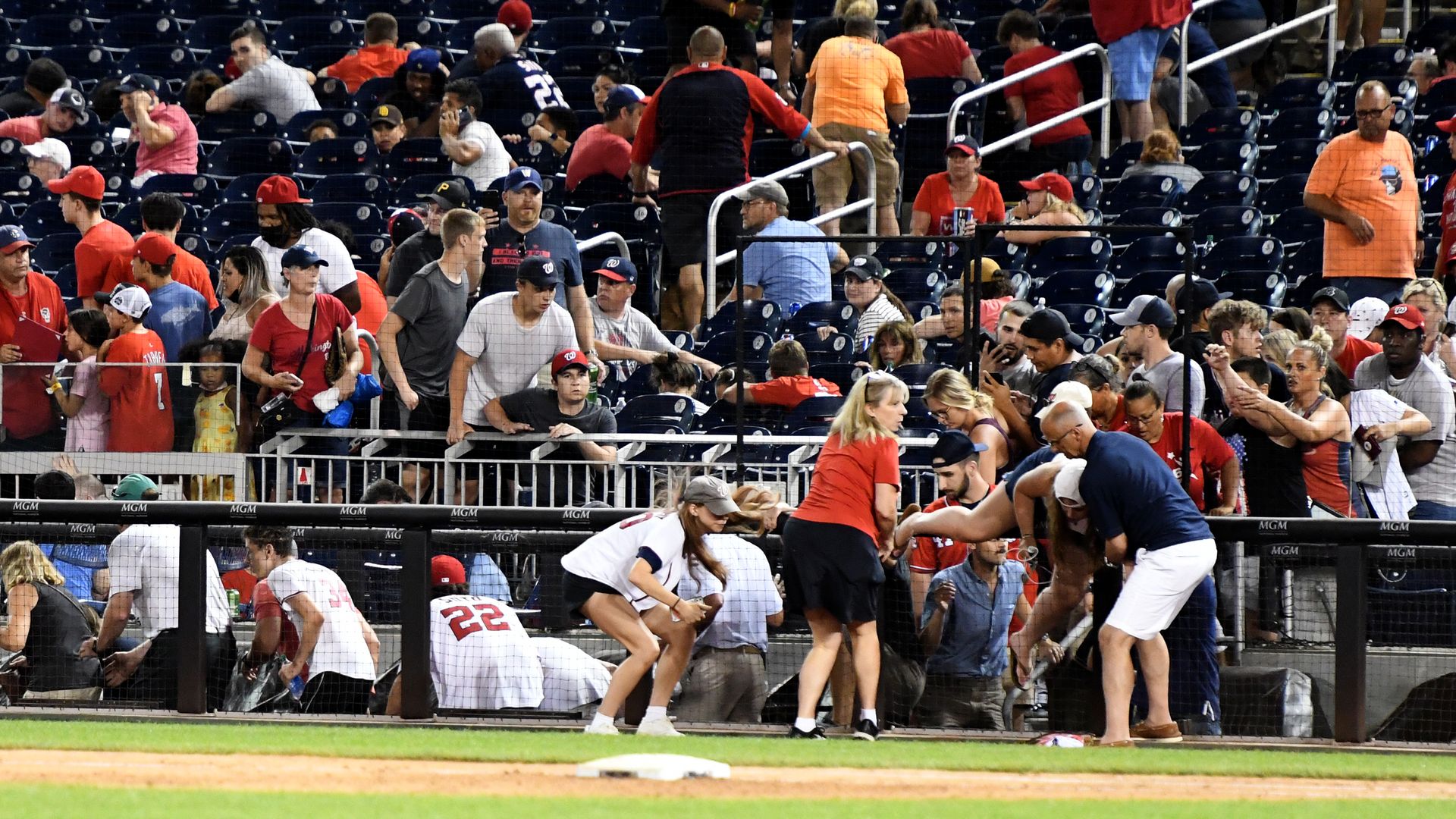  Fans run for cover after what was believed to be shots were heard during a baseball game between the San Diego Padres the Washington Nationals at Nationals Park on July 17, 2021 in Washington, DC. 