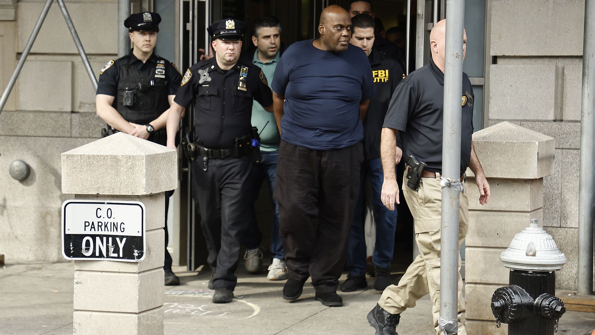 Frank James being led out of a police precinct after carrying out a mass shooting at a subway station in Brooklyn in April 2020.