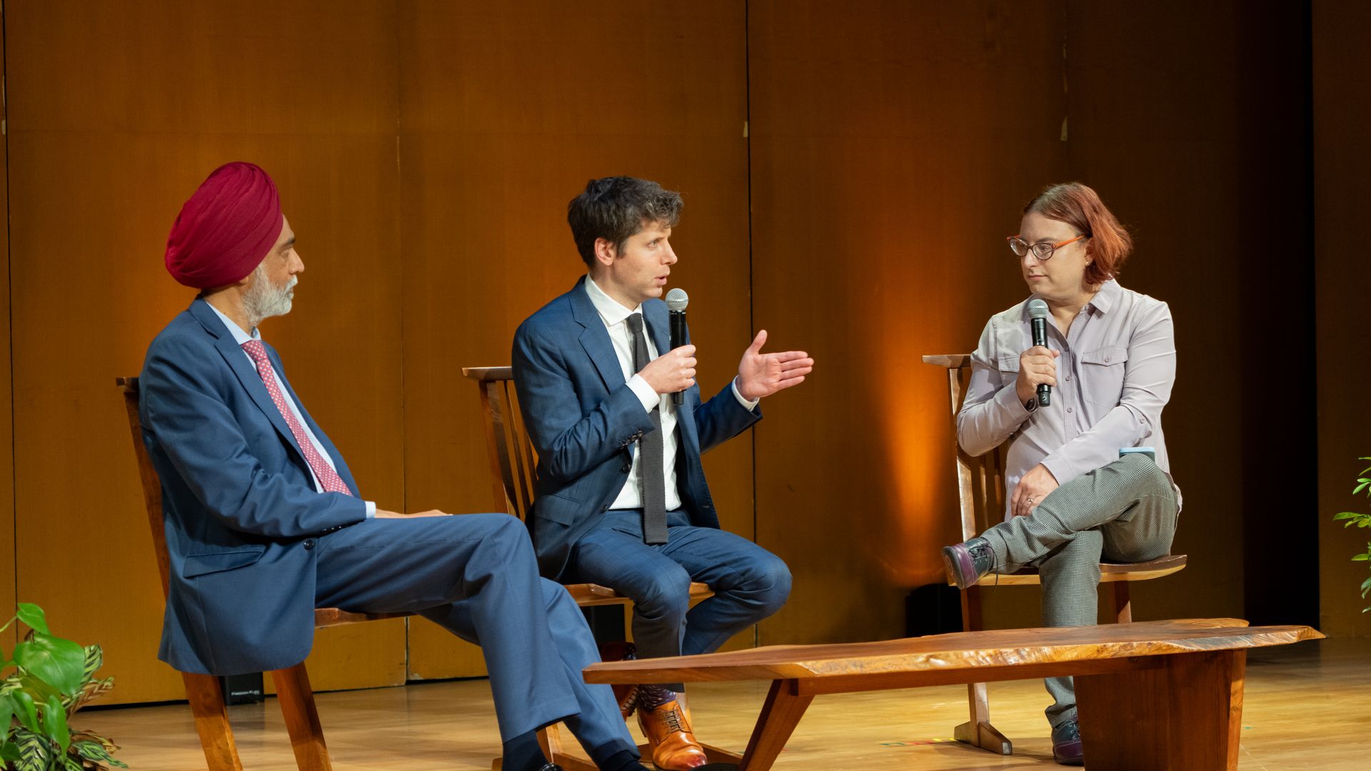 OpenAI CEO Sam Altman (center) speaks Monday with Axios' Ina Fried (right) and UN Tech Envoy Amandeep Singh Gill (left).