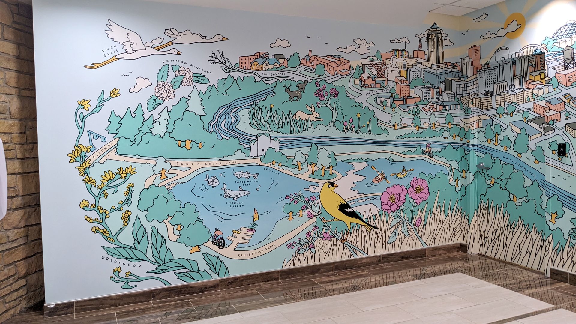A mural showing iowa's bird and the city landscape
