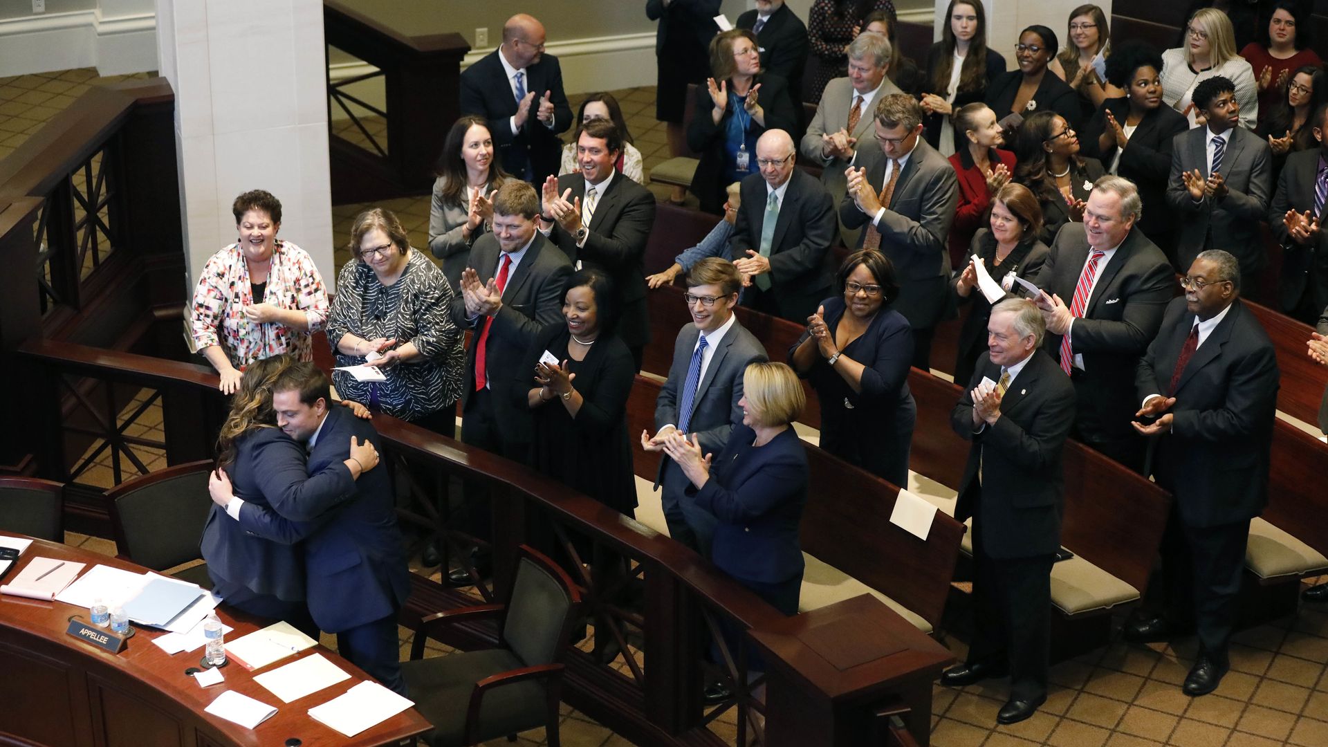 Law students hug after moot court competition. 