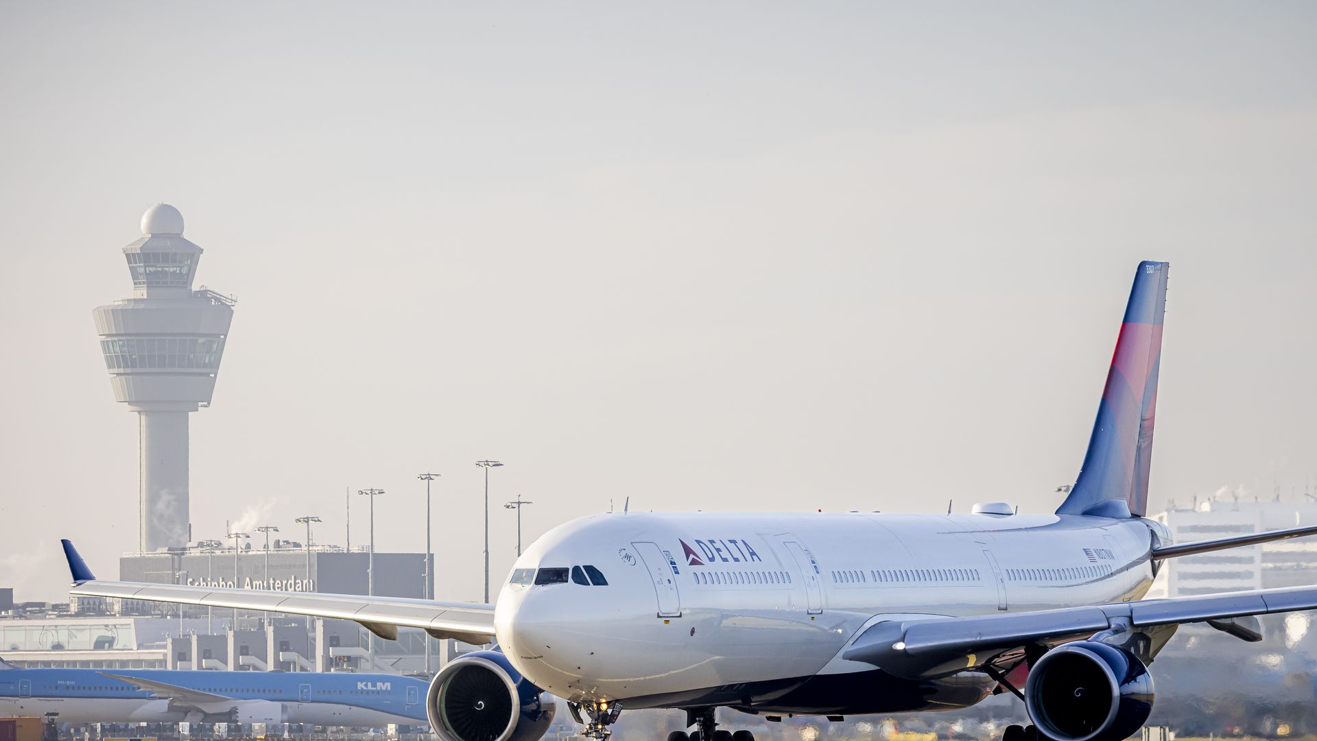 White Delta Airlines plane with red and blue tail on the runway