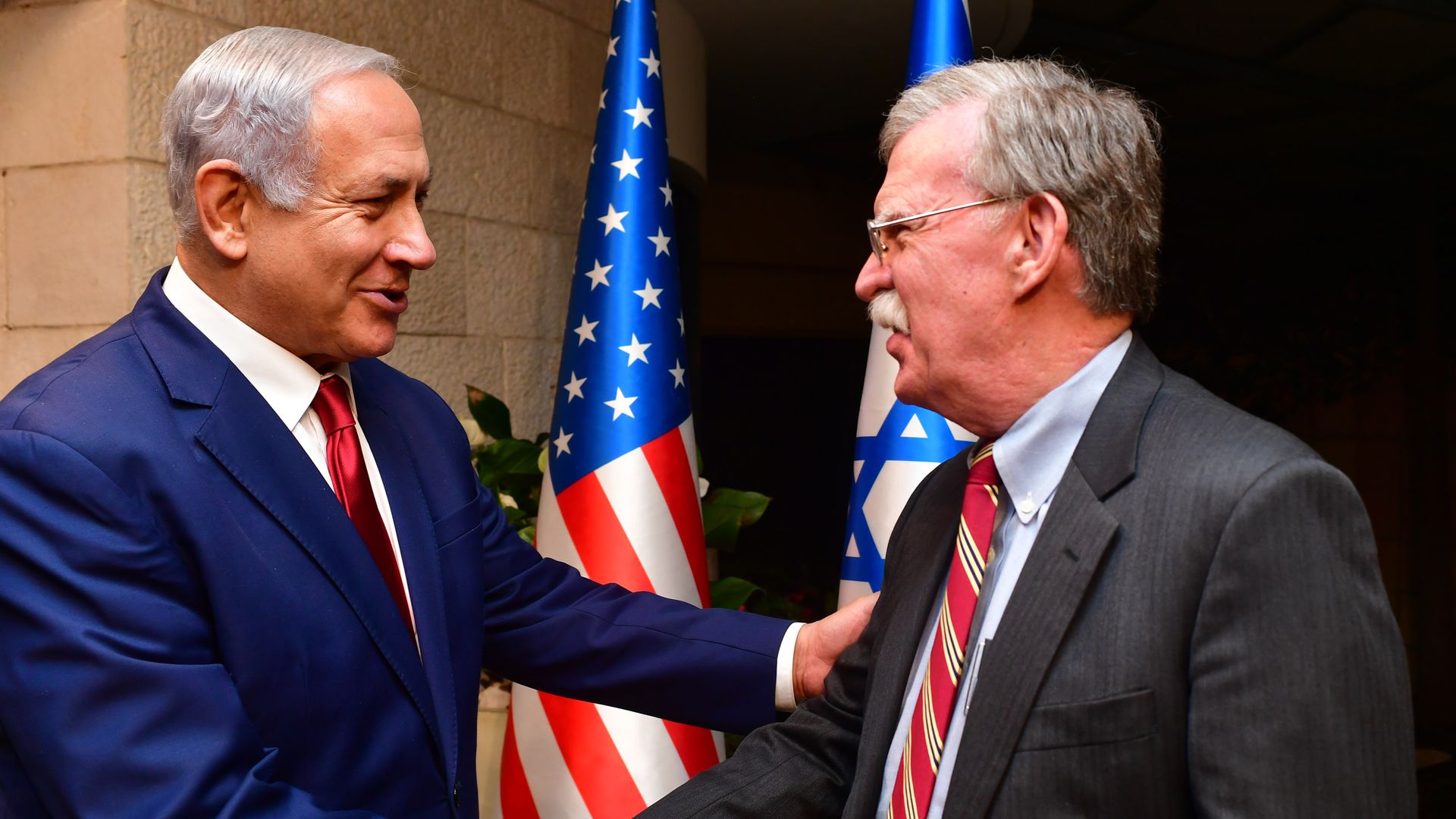 John Bolton shaking hands with Netanyahu