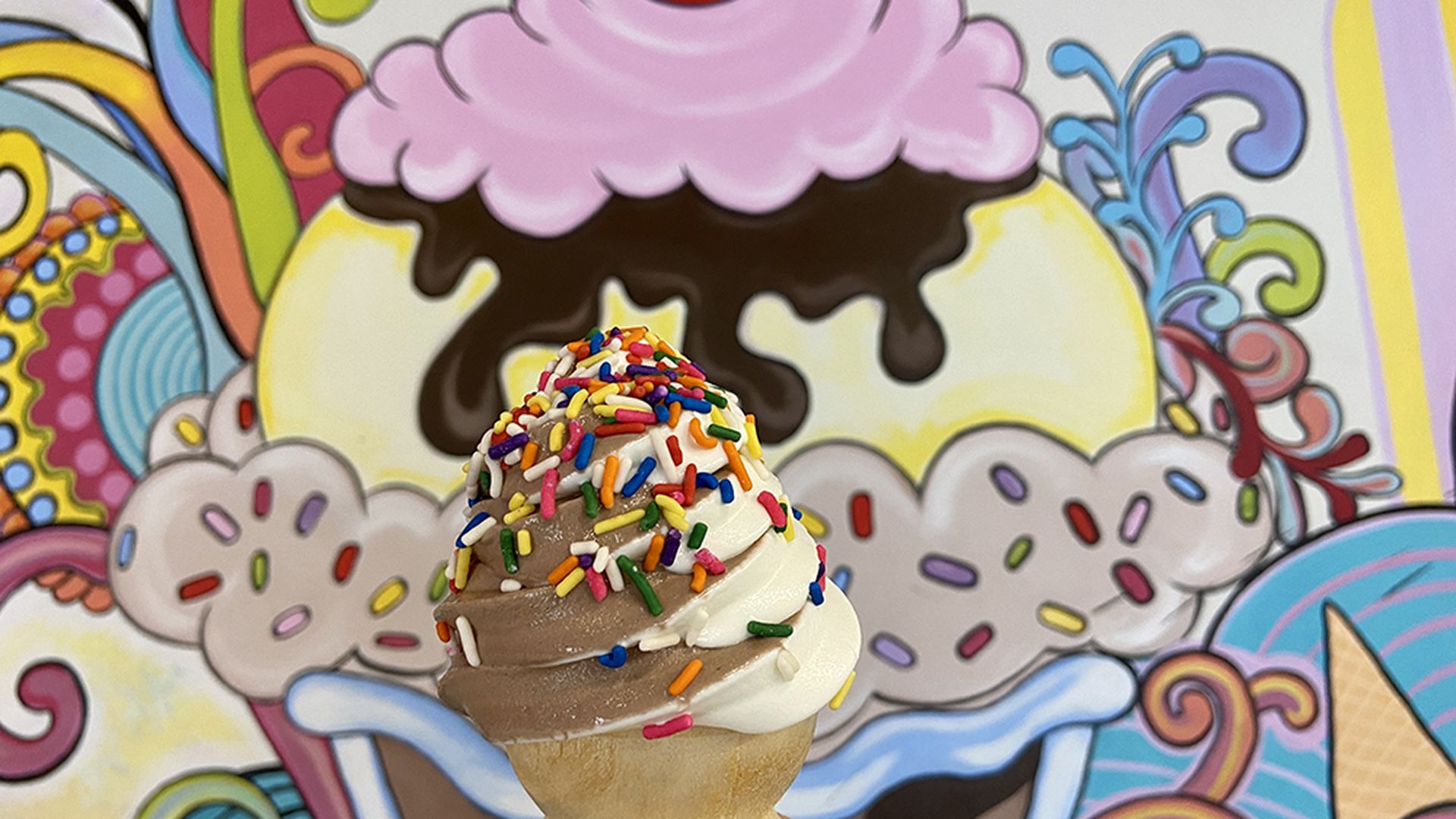 Soft-serve swirl in a cake cone with rainbow sprinkles at Two Scoops Creamery. Photo: Ashley Mahoney/Axios