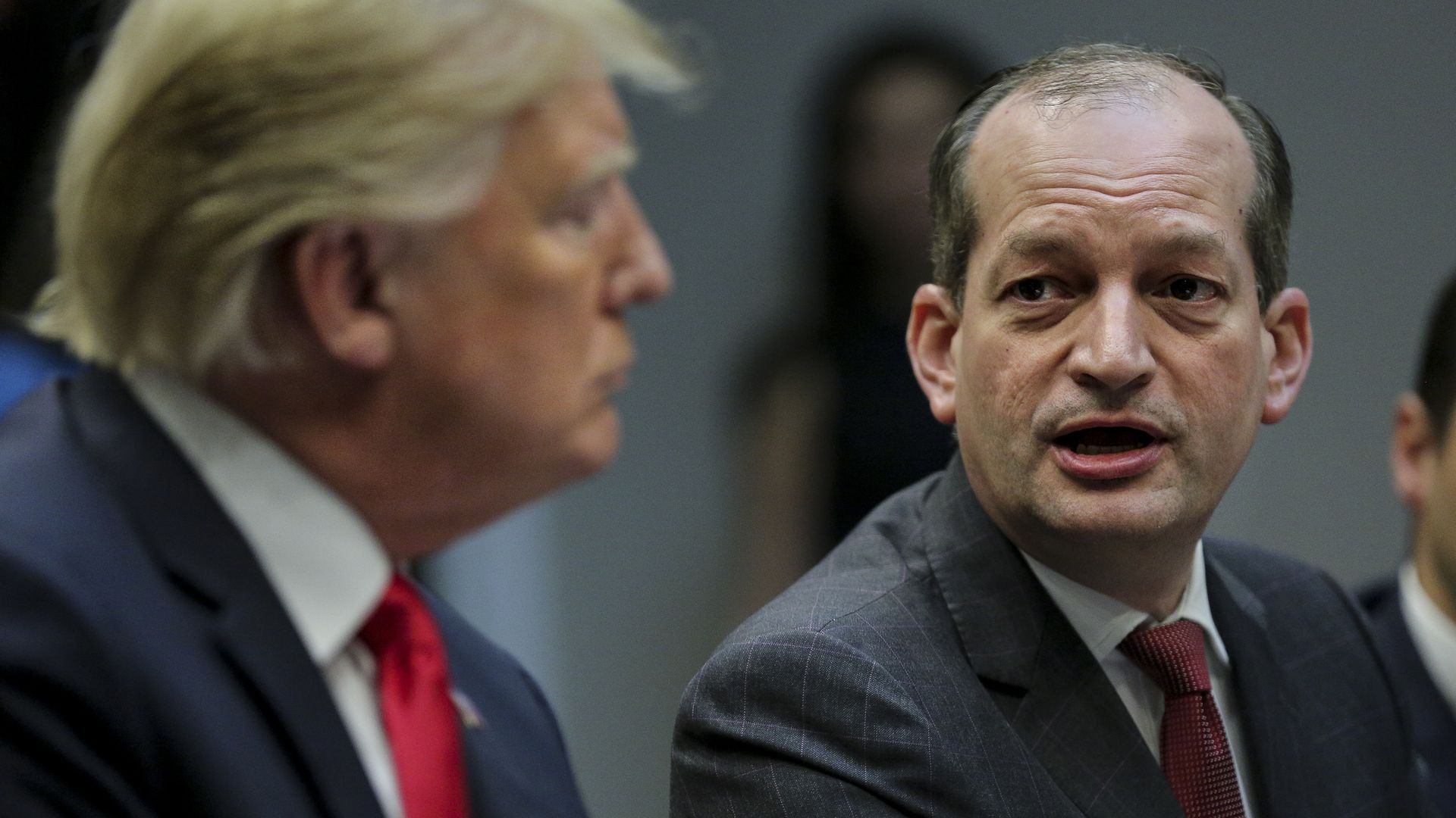 Secretary of Labor Alex Acosta, (R) speaks as U.S. President Donald Trump listens in Washington, DC.
