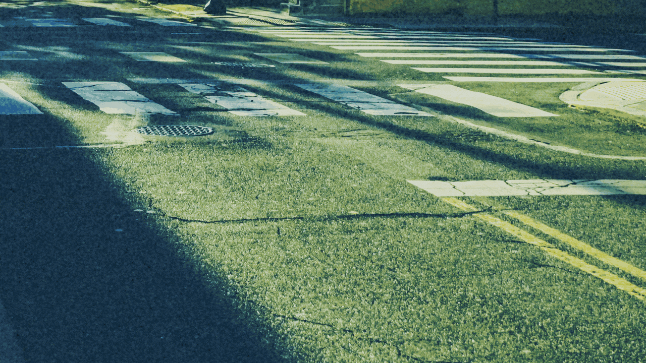 Animated illustration of a gigantic broom sweeping a street.