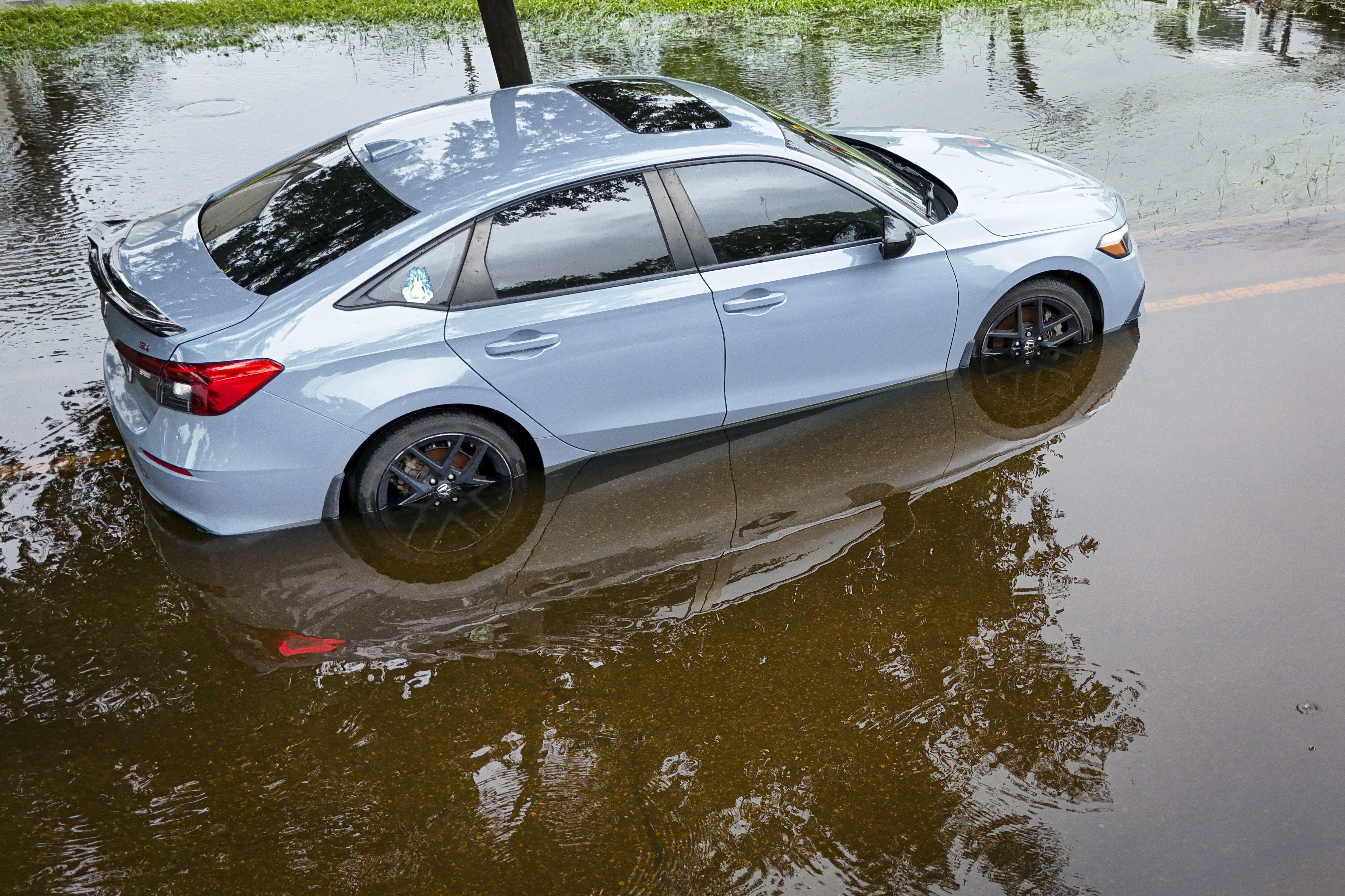 A car in a flooded street 