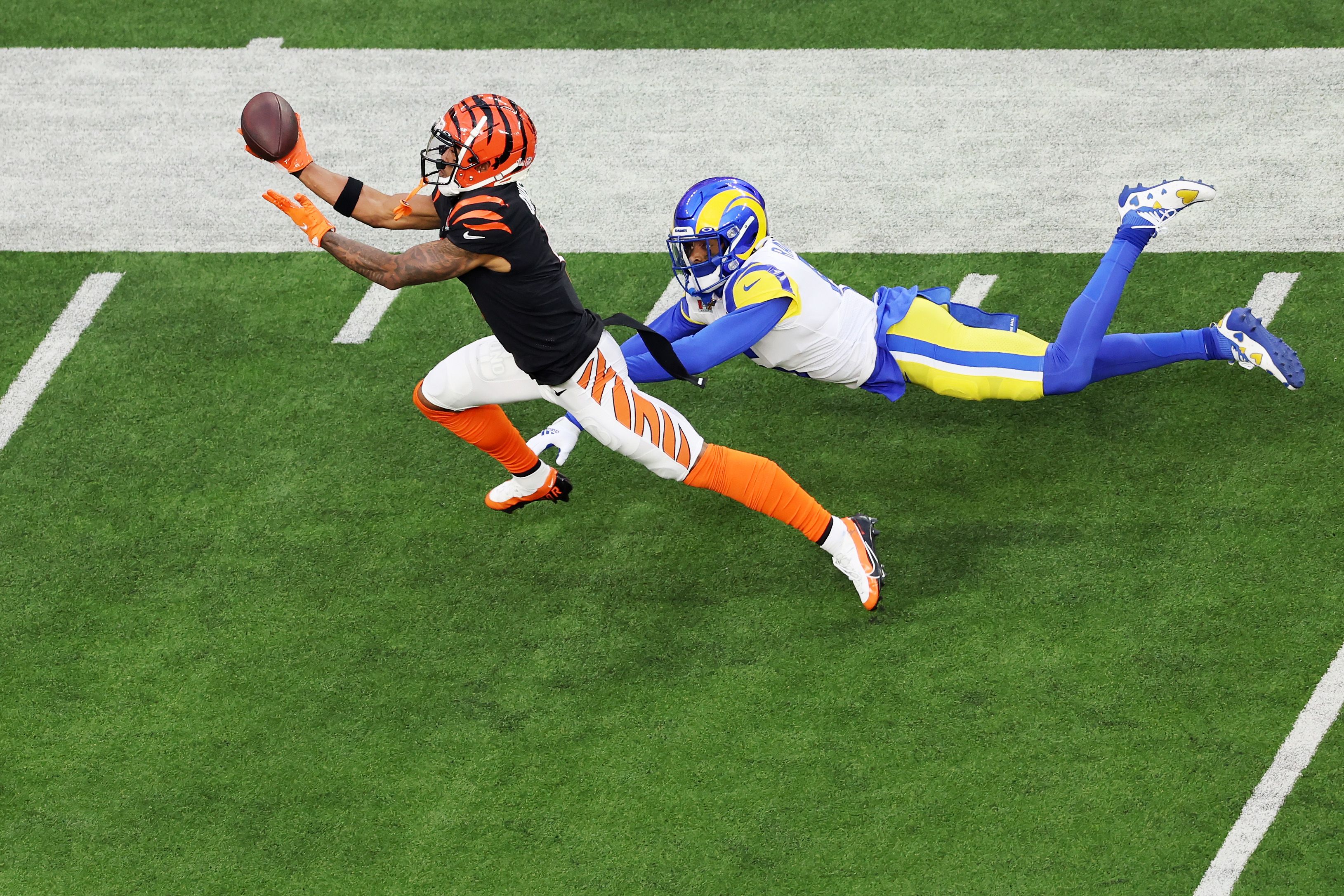 Ja'Marr Chase #1 of the Cincinnati Bengals makes a catch over Jalen Ramsey #5 of the Los Angeles Rams during Super Bowl LVI at SoFi Stadium on February 13, 2022 in Inglewood, California