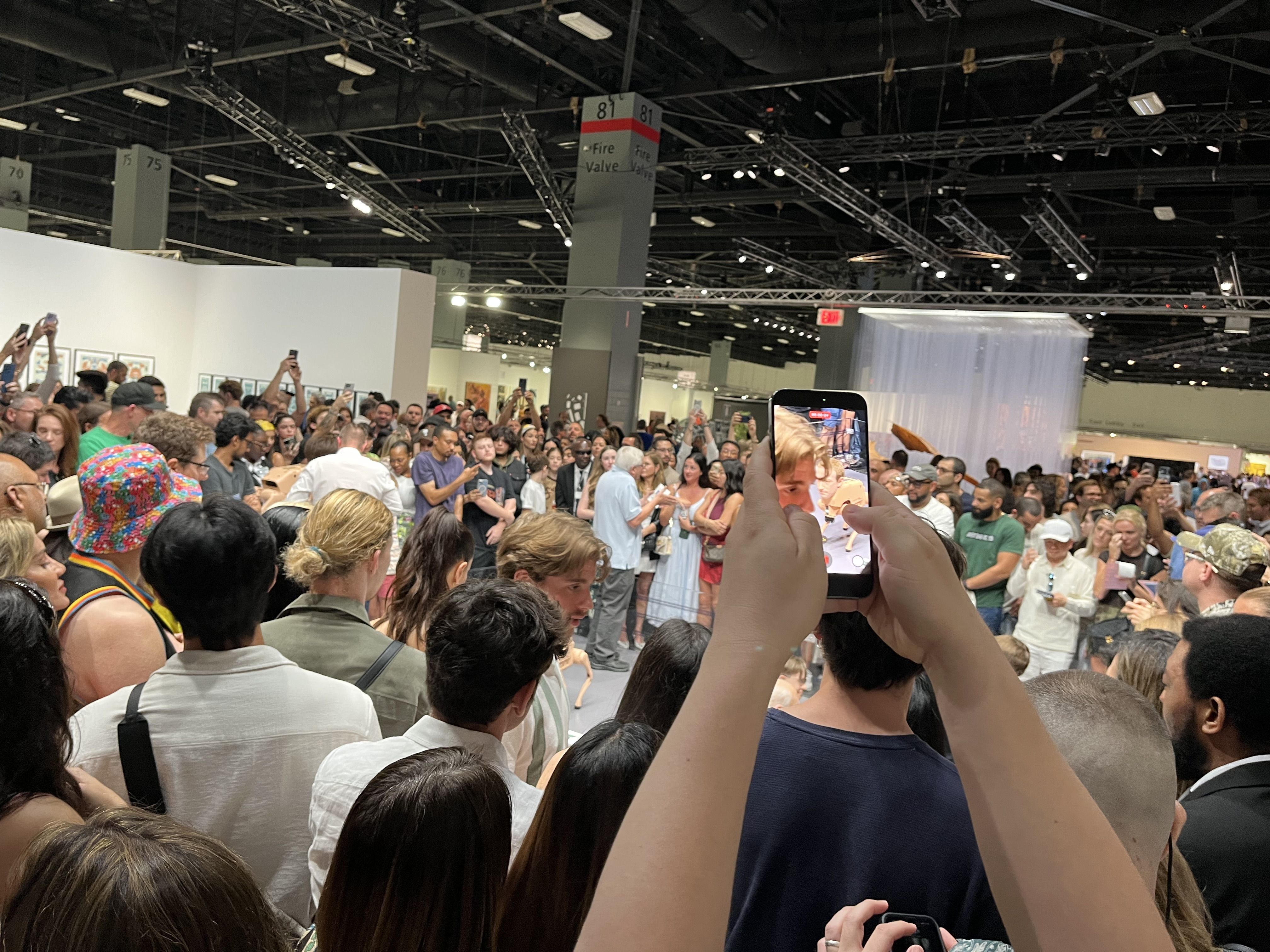 Crowd surrounds "Regular Animals" exhibit