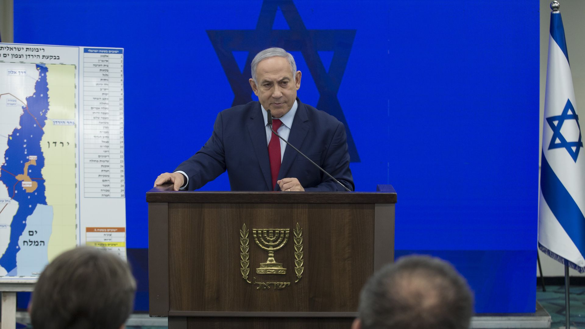 Benjamin Netanyahu stands at a podium to announce annexation plans.