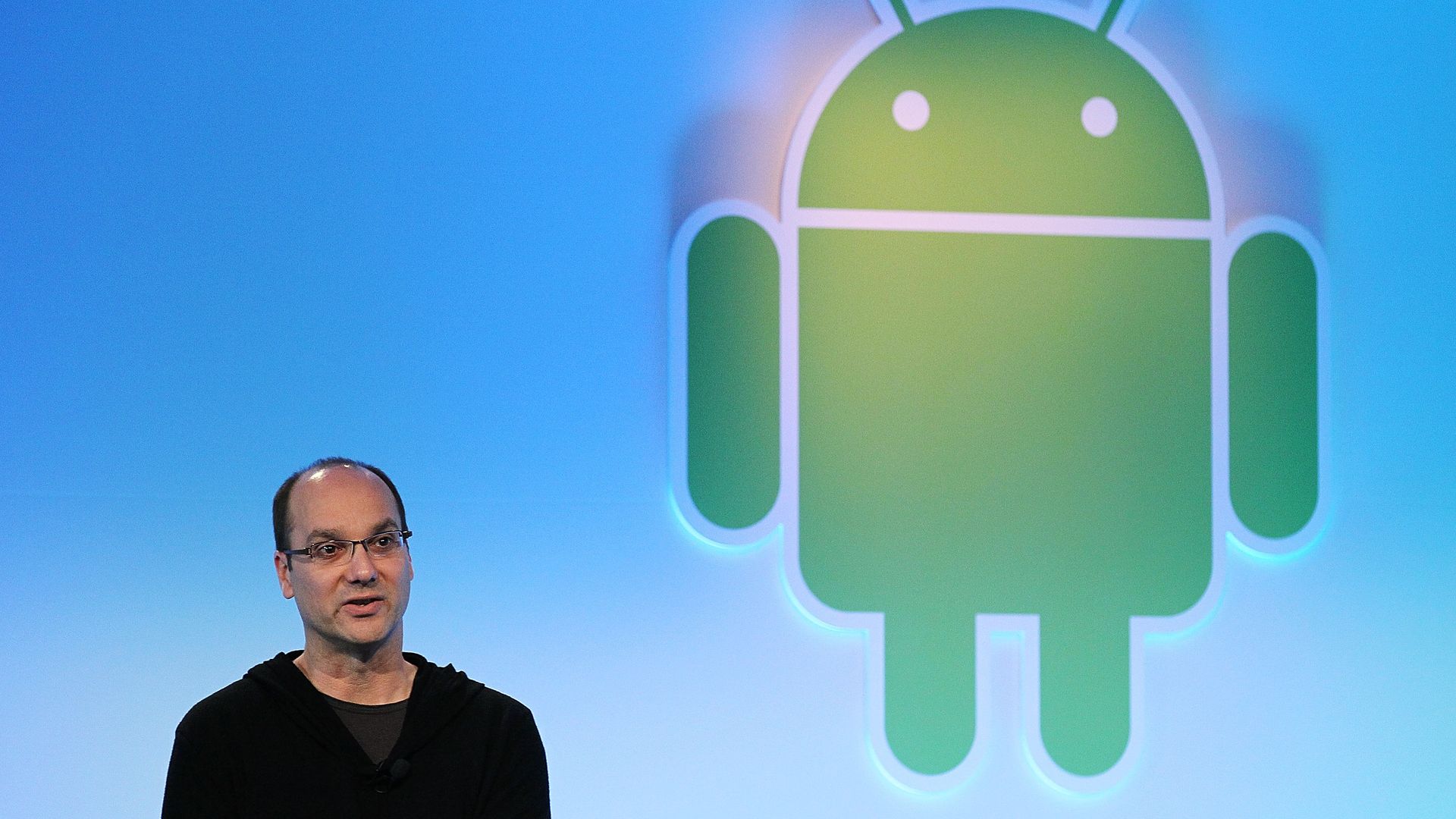 Andy Rubin standing on stage in a sweatsuit. 