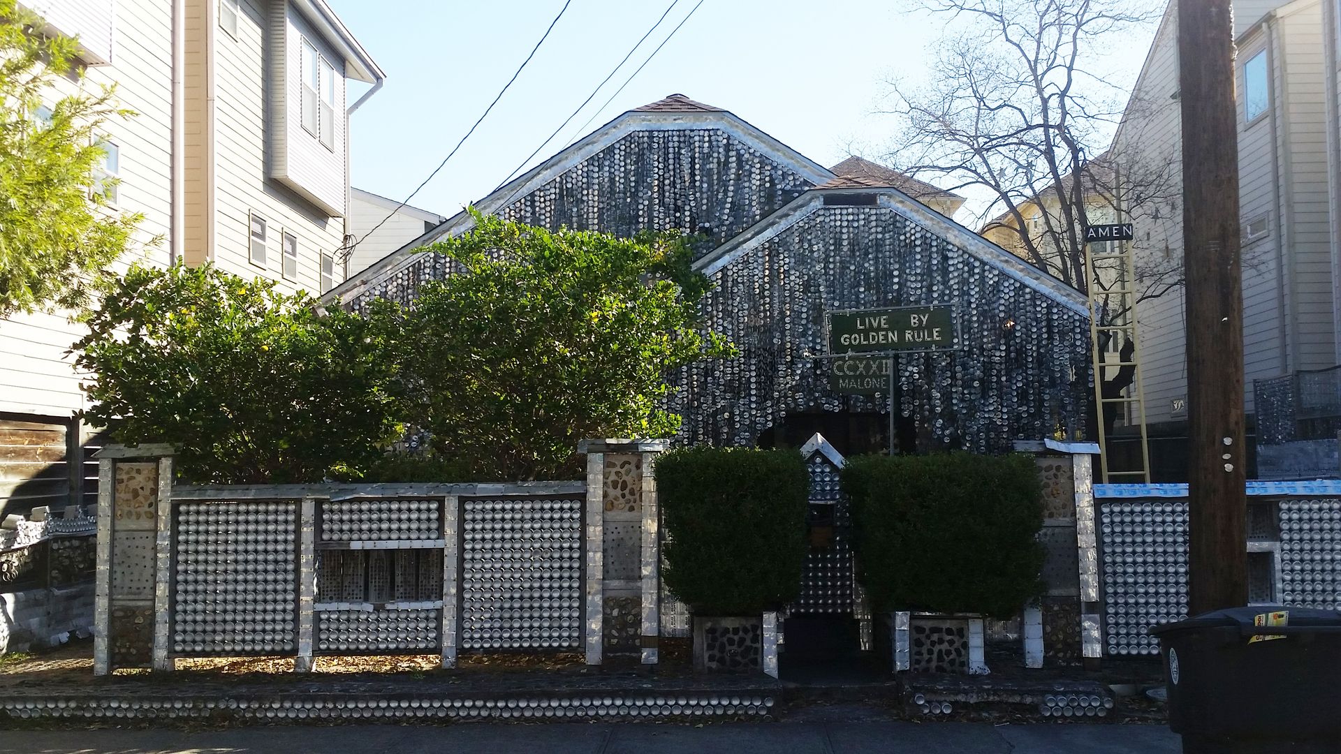 A house covered with beer cans. 