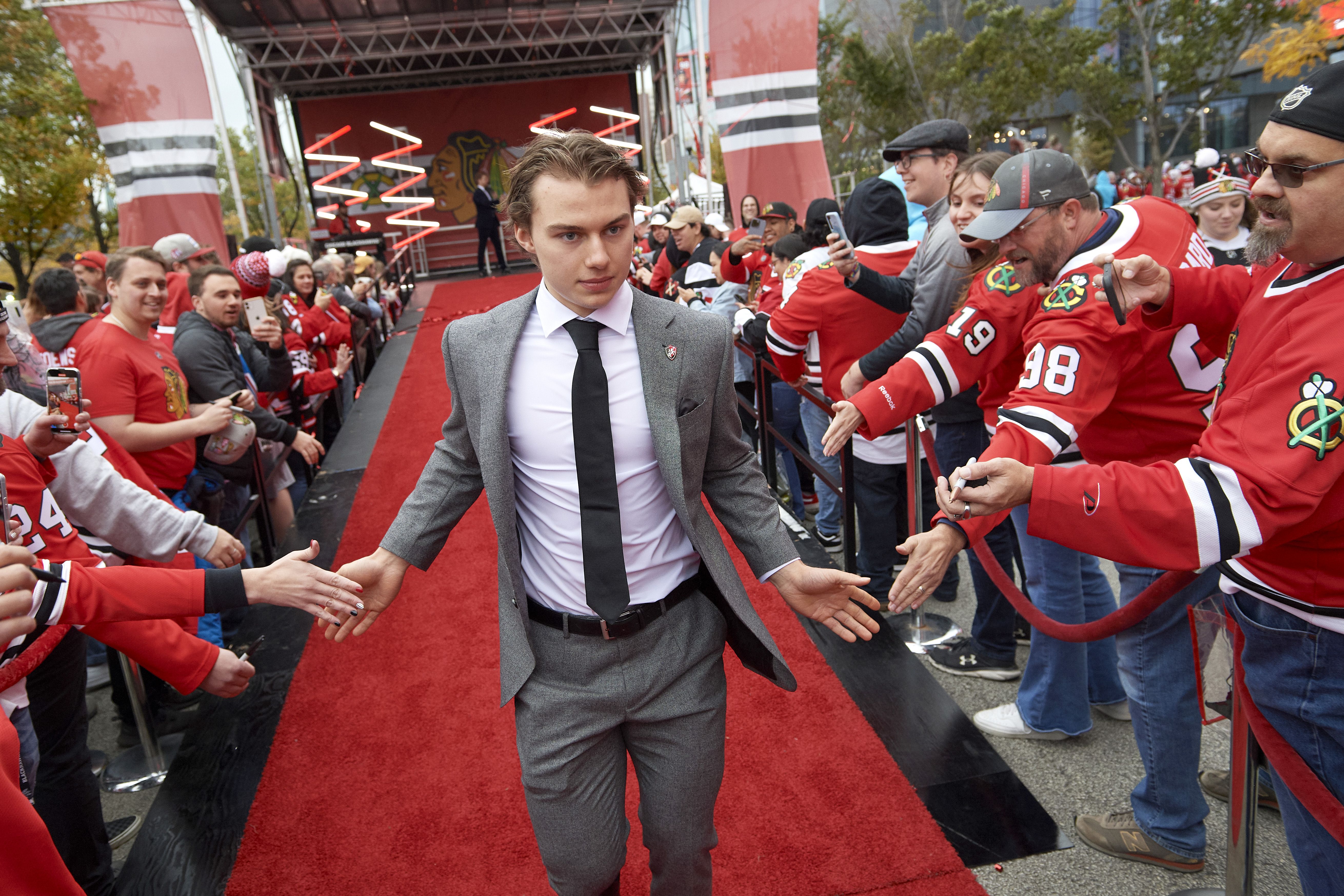 Photo of a hockey player in a suit before a game 