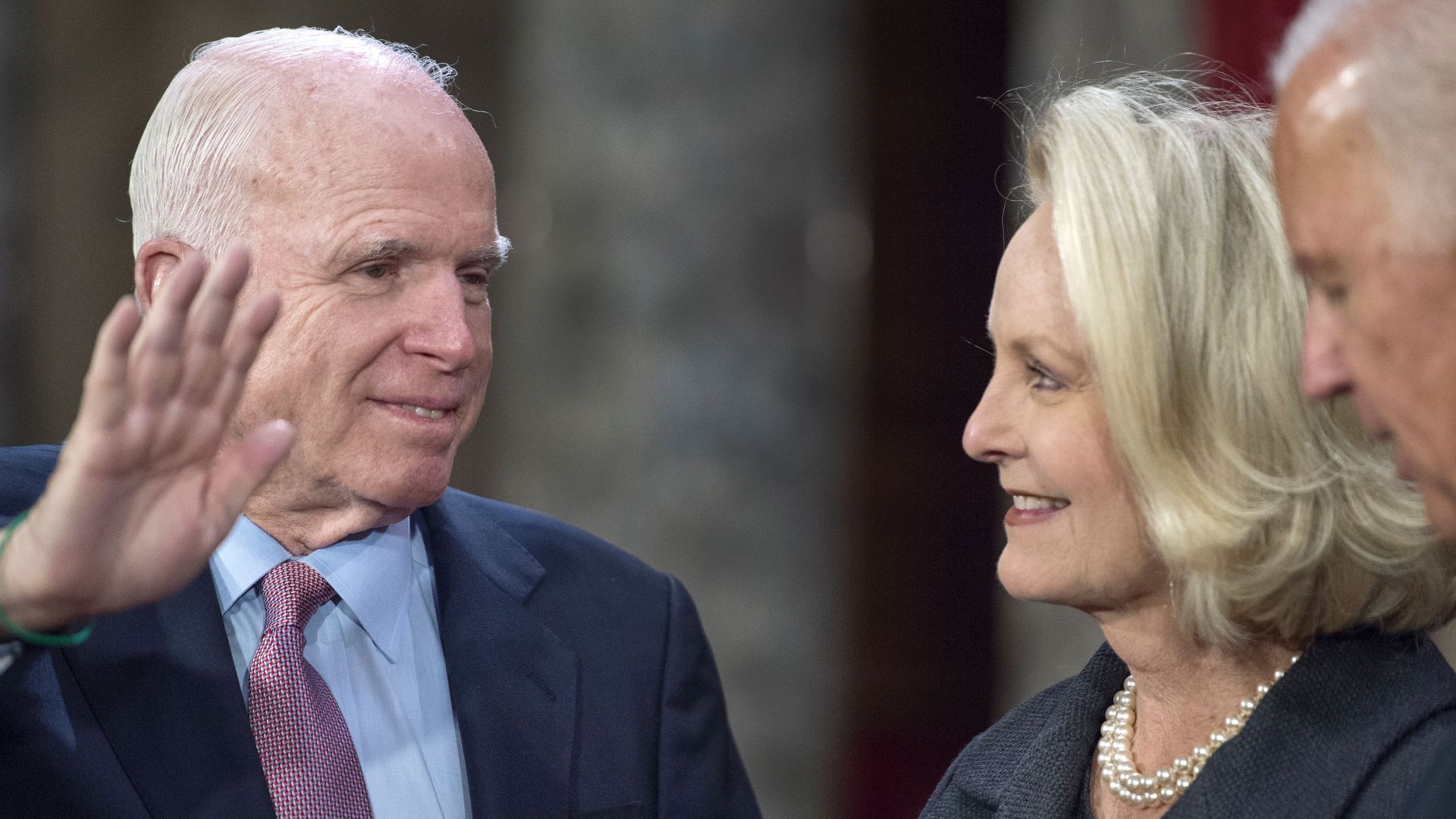 Sen. John McCain(R-AZ) sworn in by then-Vice-President Joe Biden as Cindy McCain holds the Bible during a reenacted swearing-in January 2017. Photo: Paul Richards/AFP/Getty Images