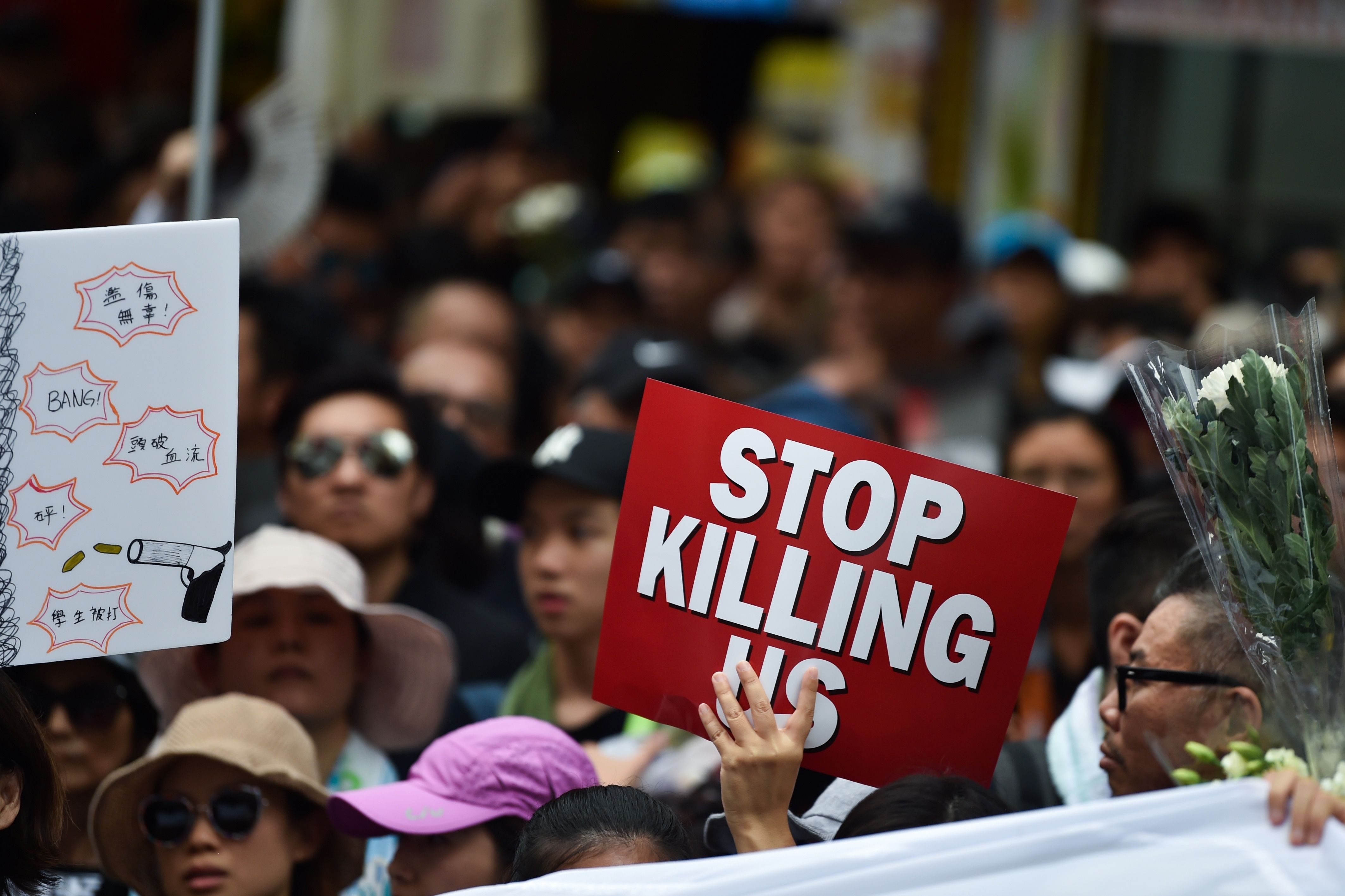 rotesters display placards during a march against a controversial extradition law proposal in Hong Kong.