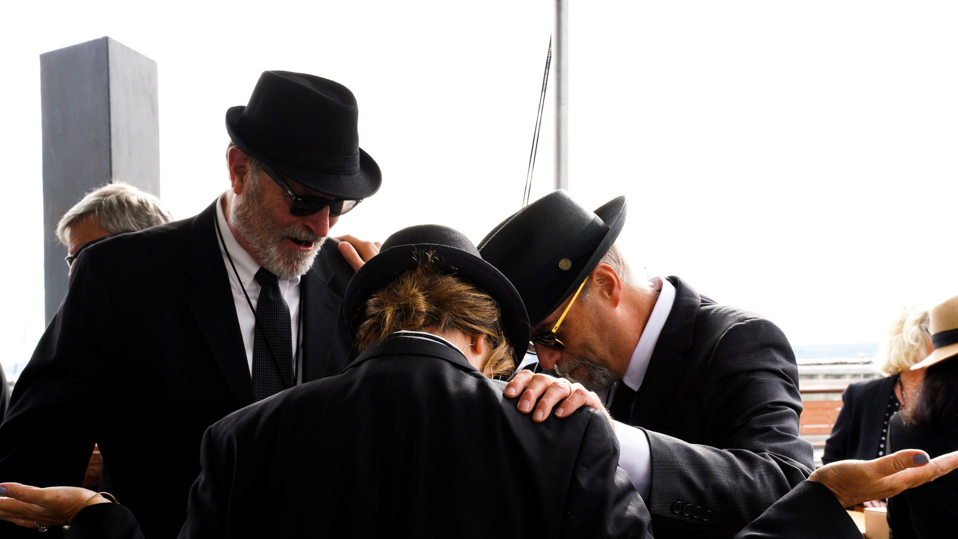 Three people dressed in black suits at the Men in Black Birthday Bash in Washington state.