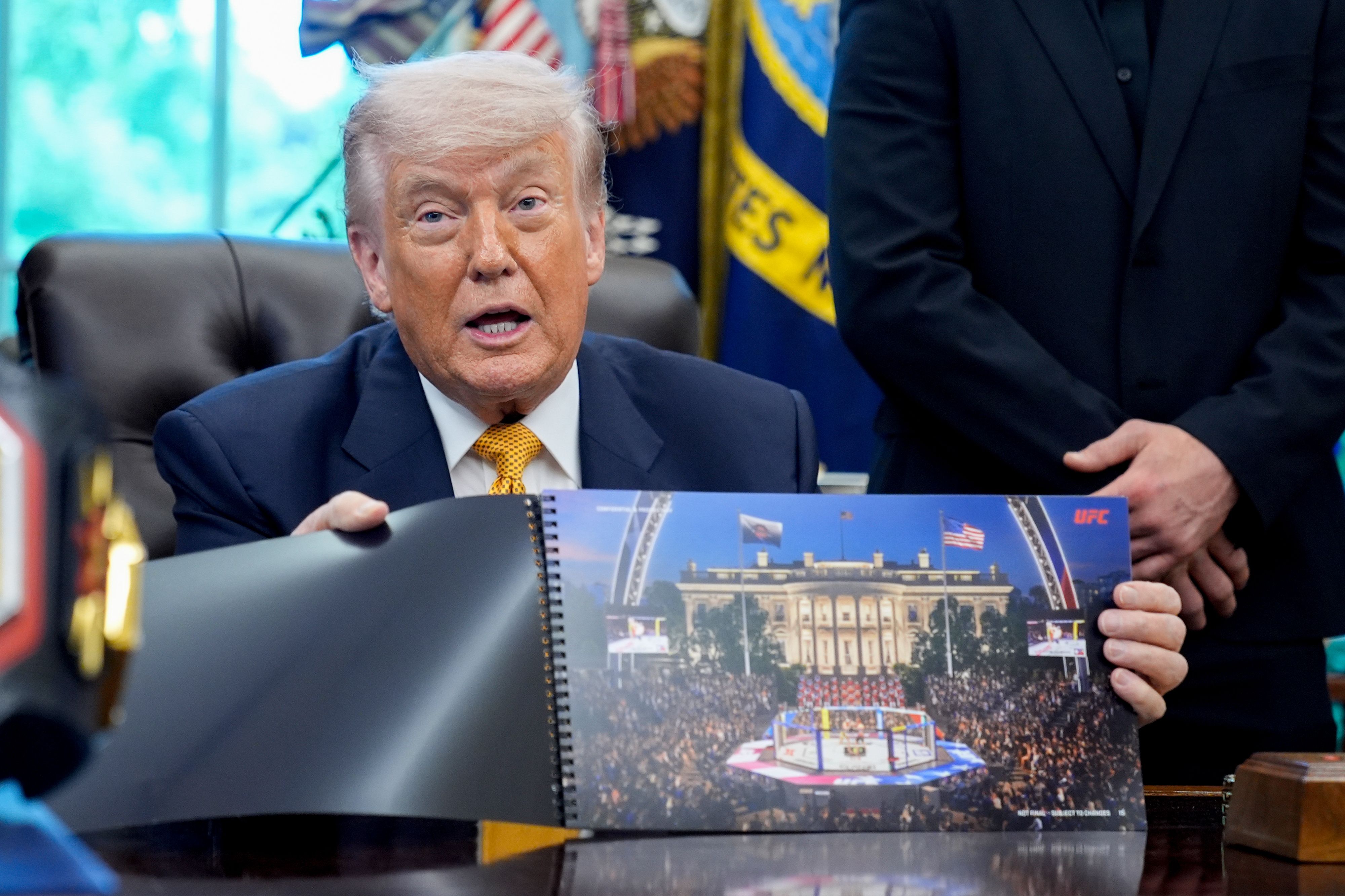 President Trump holds up a rendering of the arena for the UFC's Freedom 250 event at the White House on June 14.