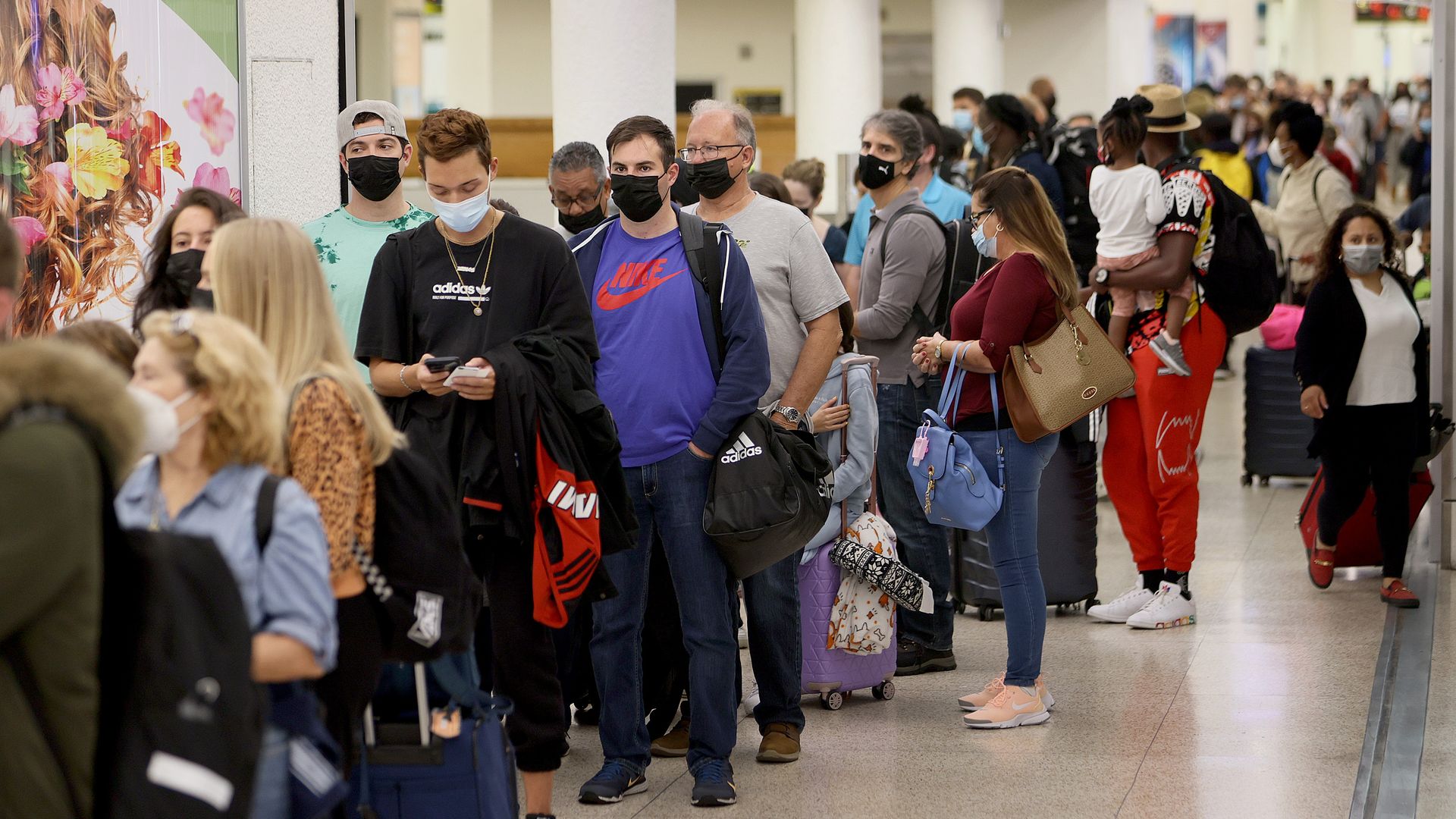 Image of a long line of passengers at Miami International Airport around Thanksgiving. 
