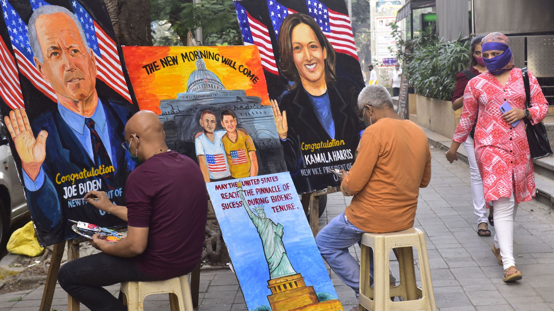 Artists are seen painting portraits of President Biden and Vice President Kamala Harris in Mumbia, India.