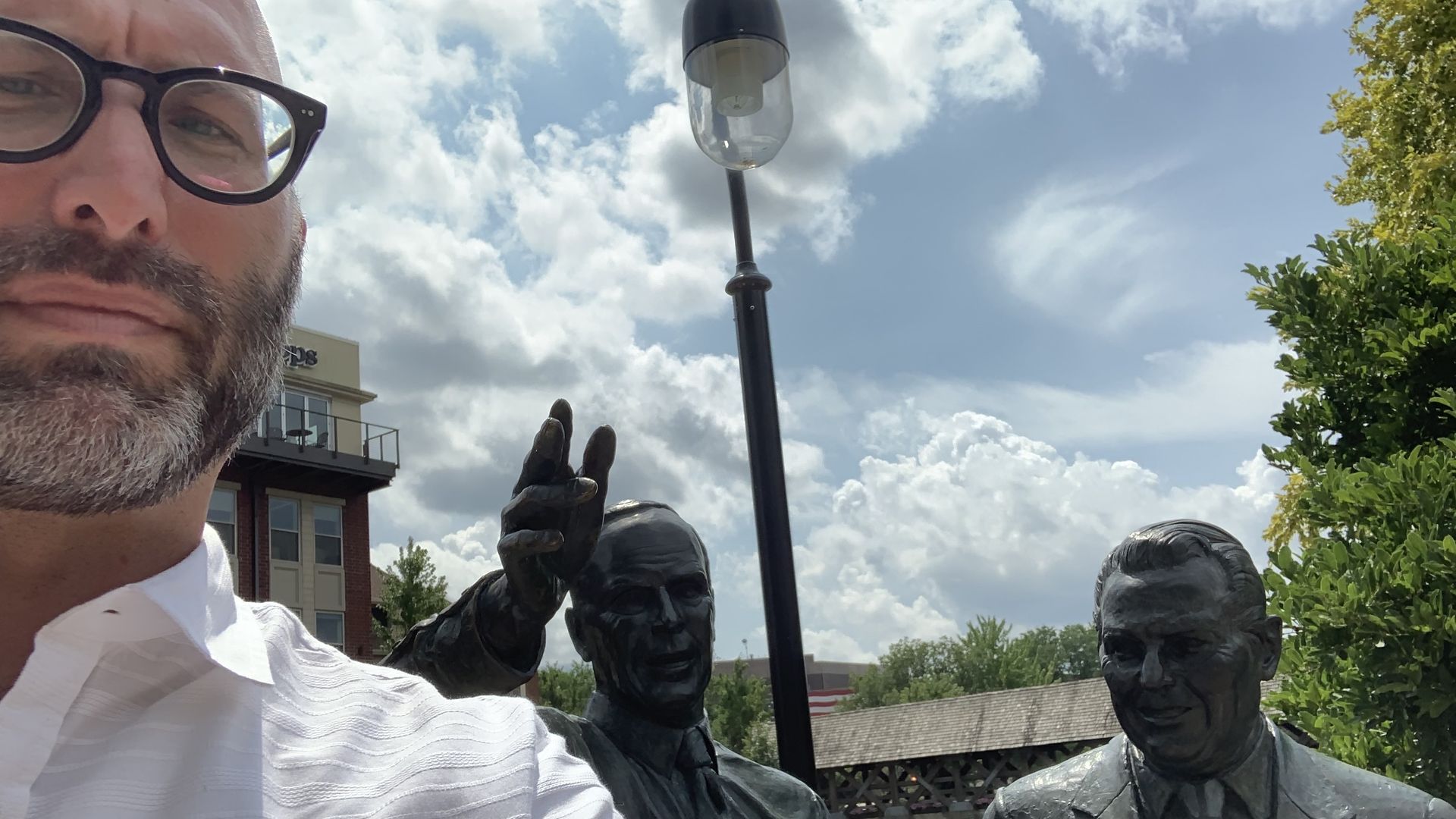 guy in front of statues 