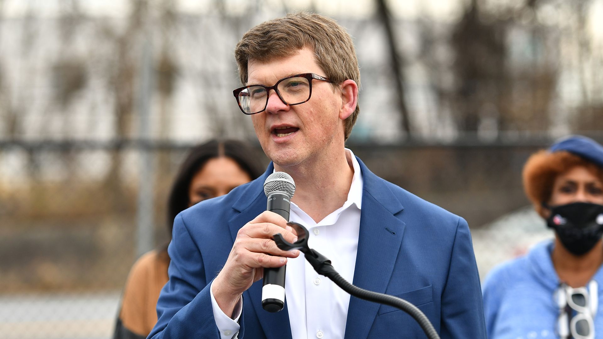 The late MARTA CEO Jeffrey Parker speaks into a microphone at an outdoor event