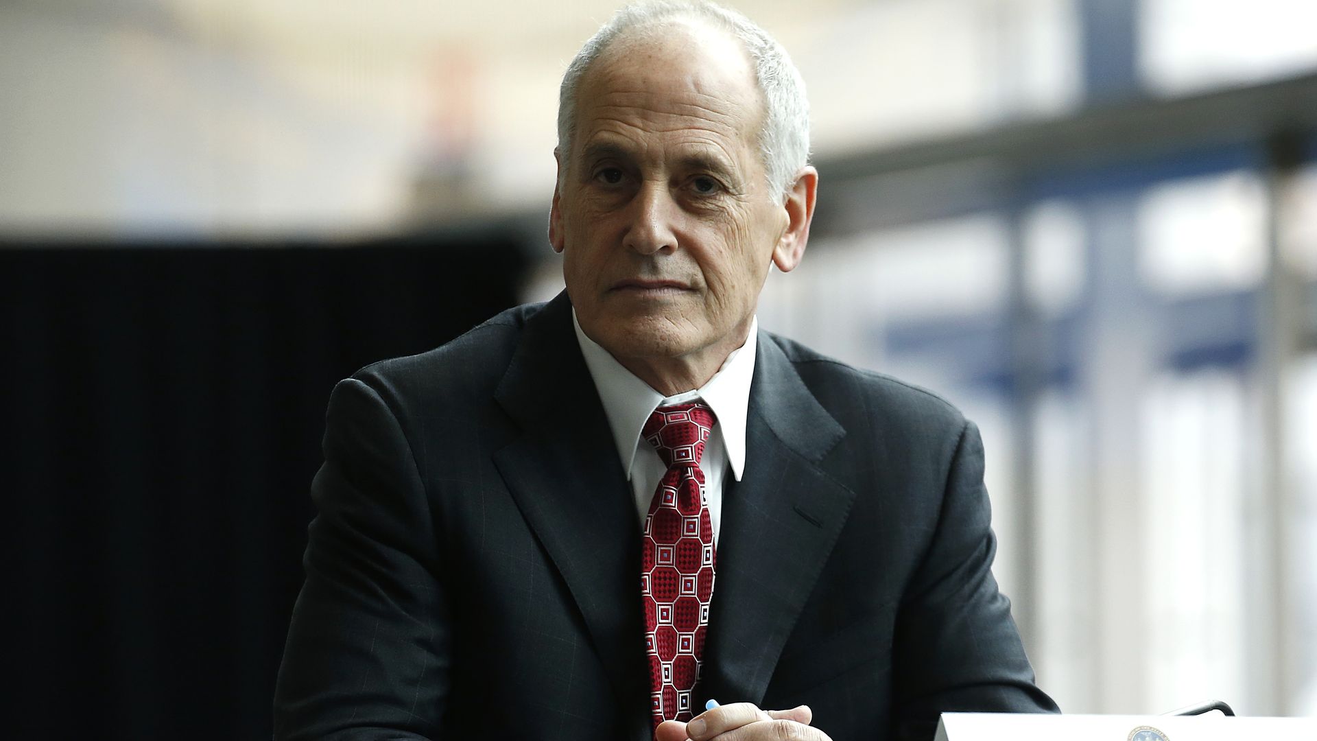 Larry Schwartz wears a suit and tie