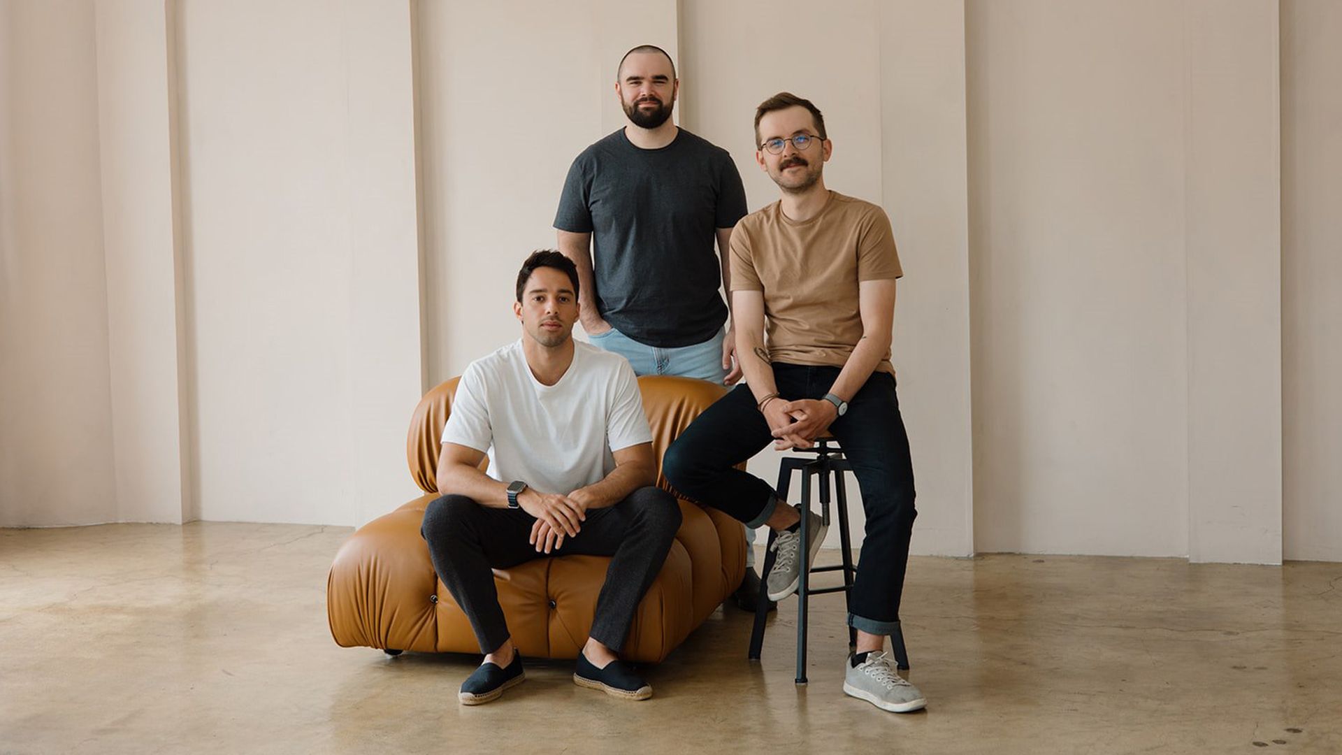 (From left) Tyler Denk on a couch, Benjamin Hargett standing and Jake Hurd sitting on a stool