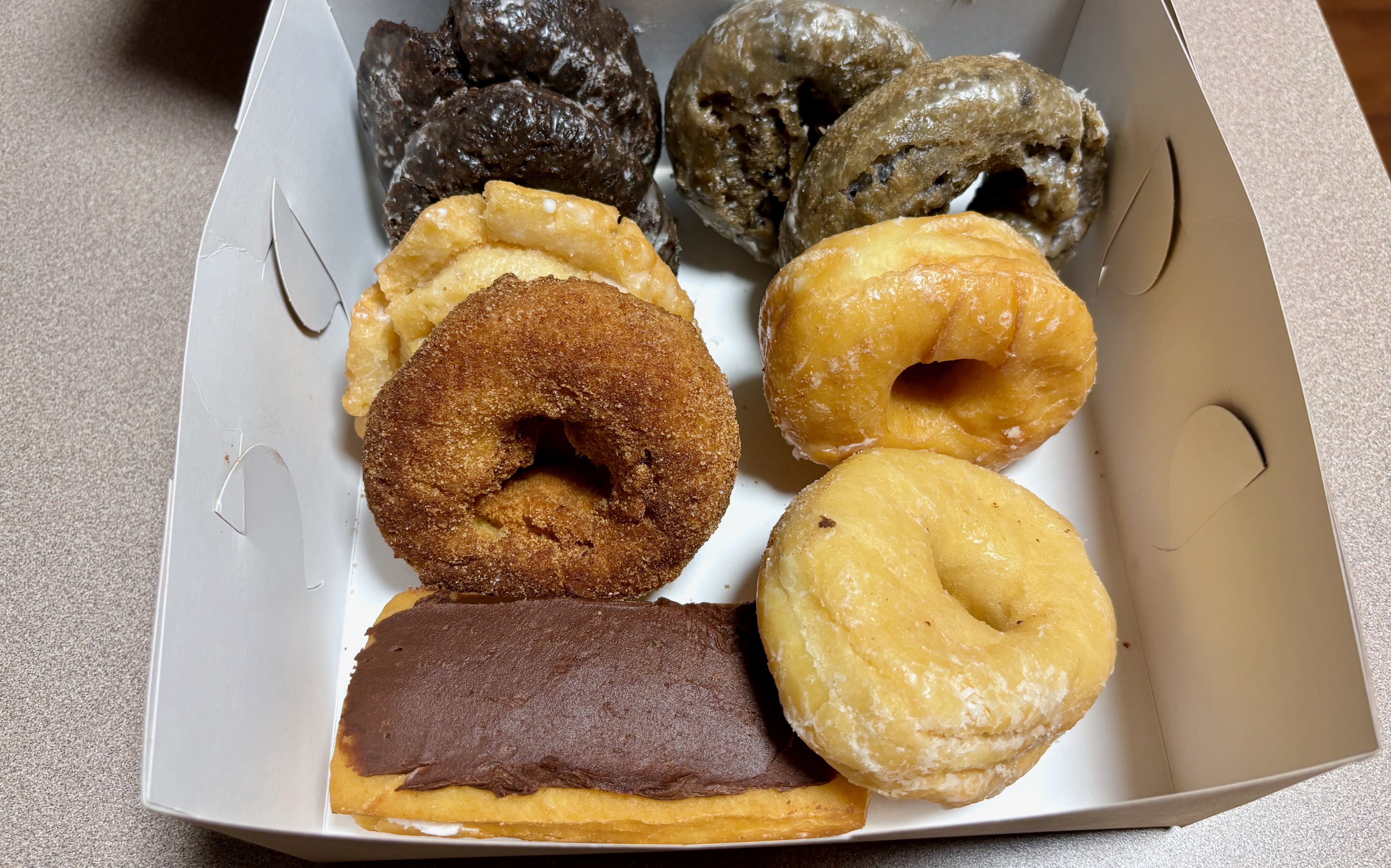 A box full of nine doughnuts