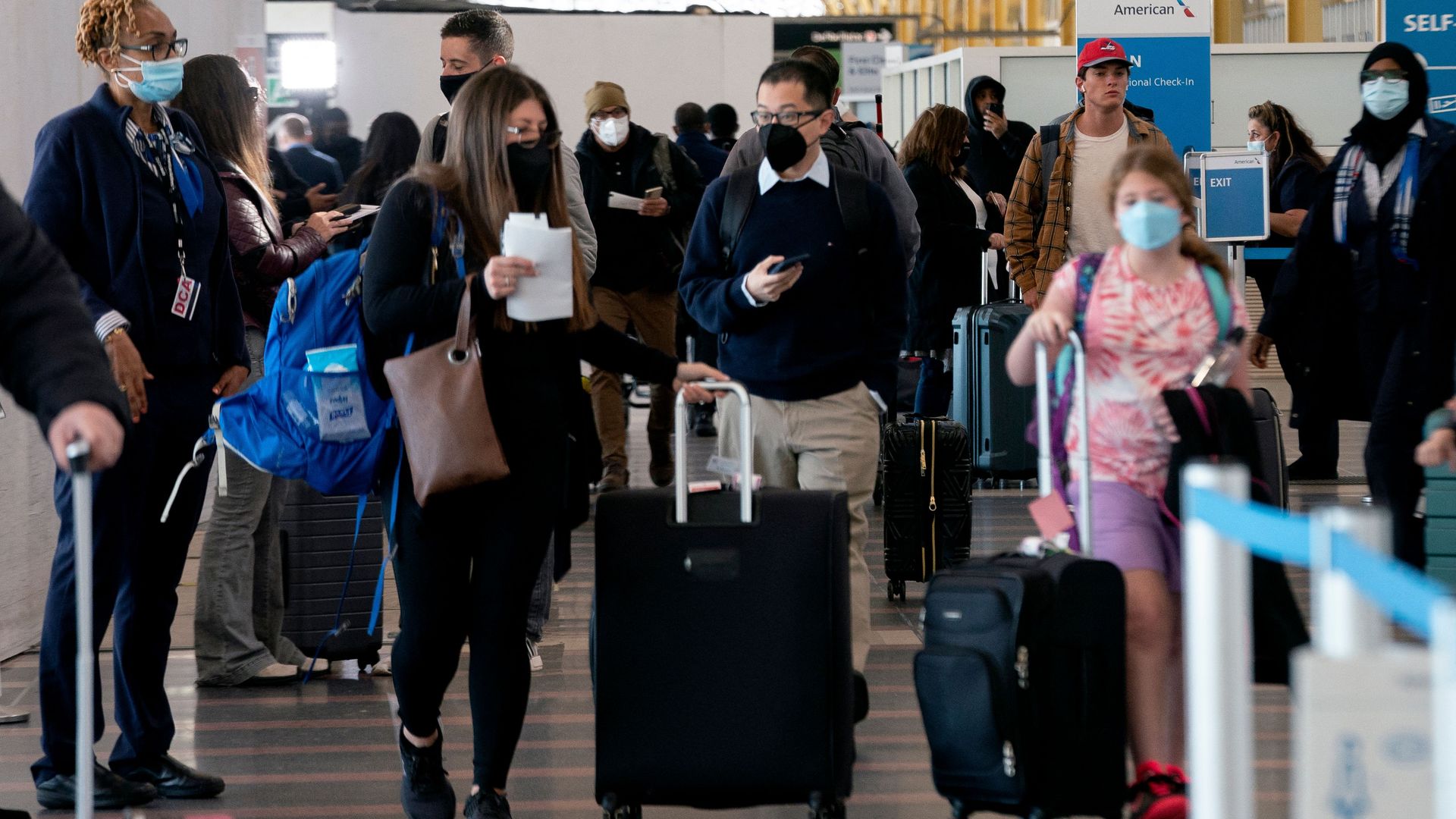 Travelers walk through Ronald Reagan Washington National Airport.