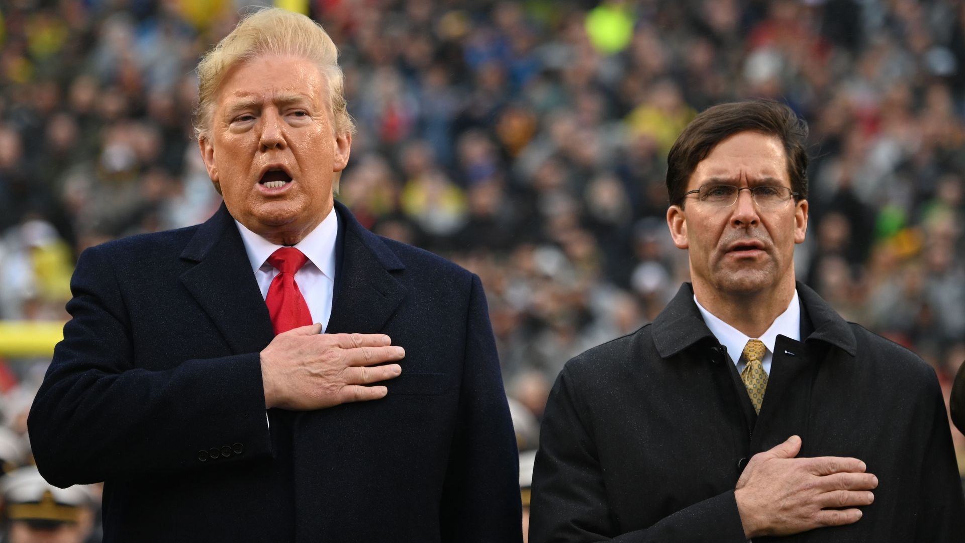 Trump and Esper with their hands over their hearts.