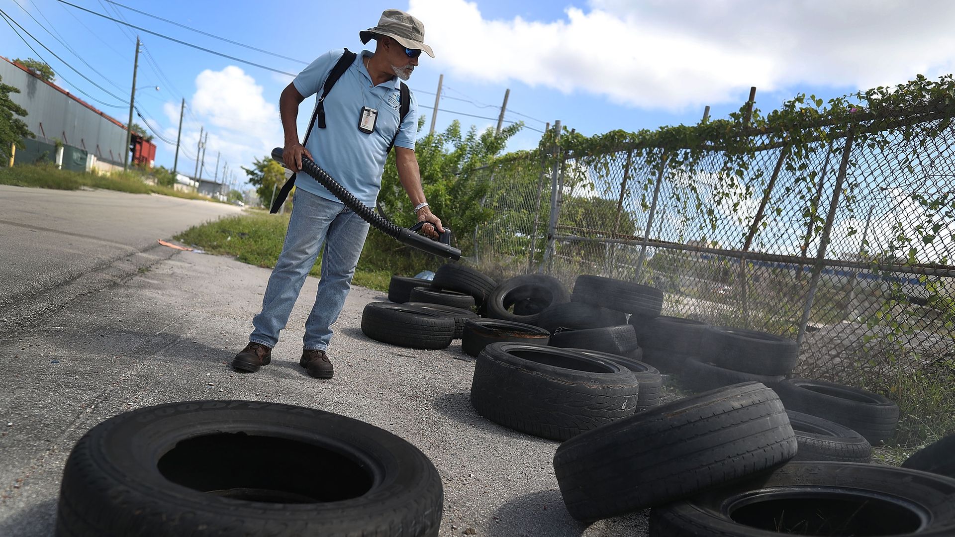 MIAMI, FL - OCTOBER 14: Nelson Tejeda, a Miami-Dade County mosquito control inspector, uses a sprayer filled with a pesticide in an attempt to kill mosquitos that are carrying the Zika virus on October 14, 2016 in Miami, Florida.
