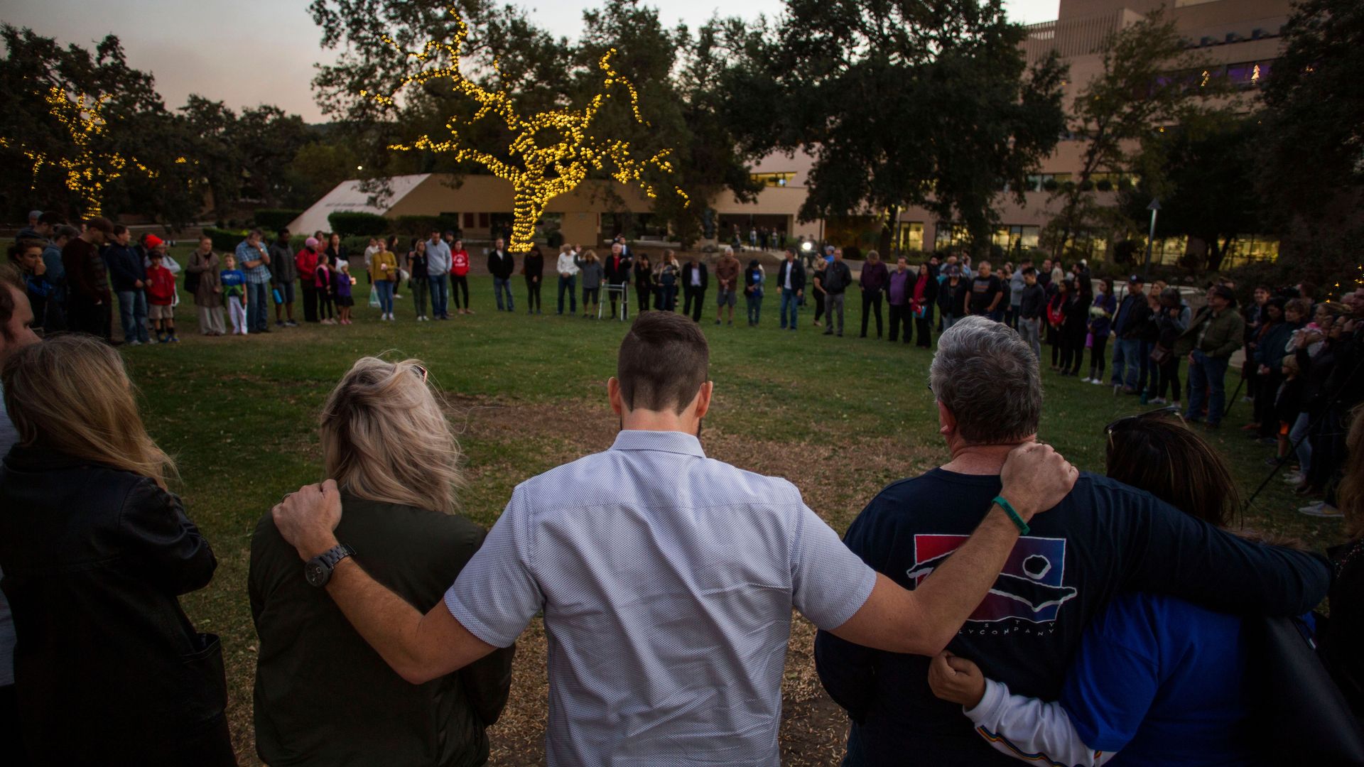 People in a circle at a vigil.