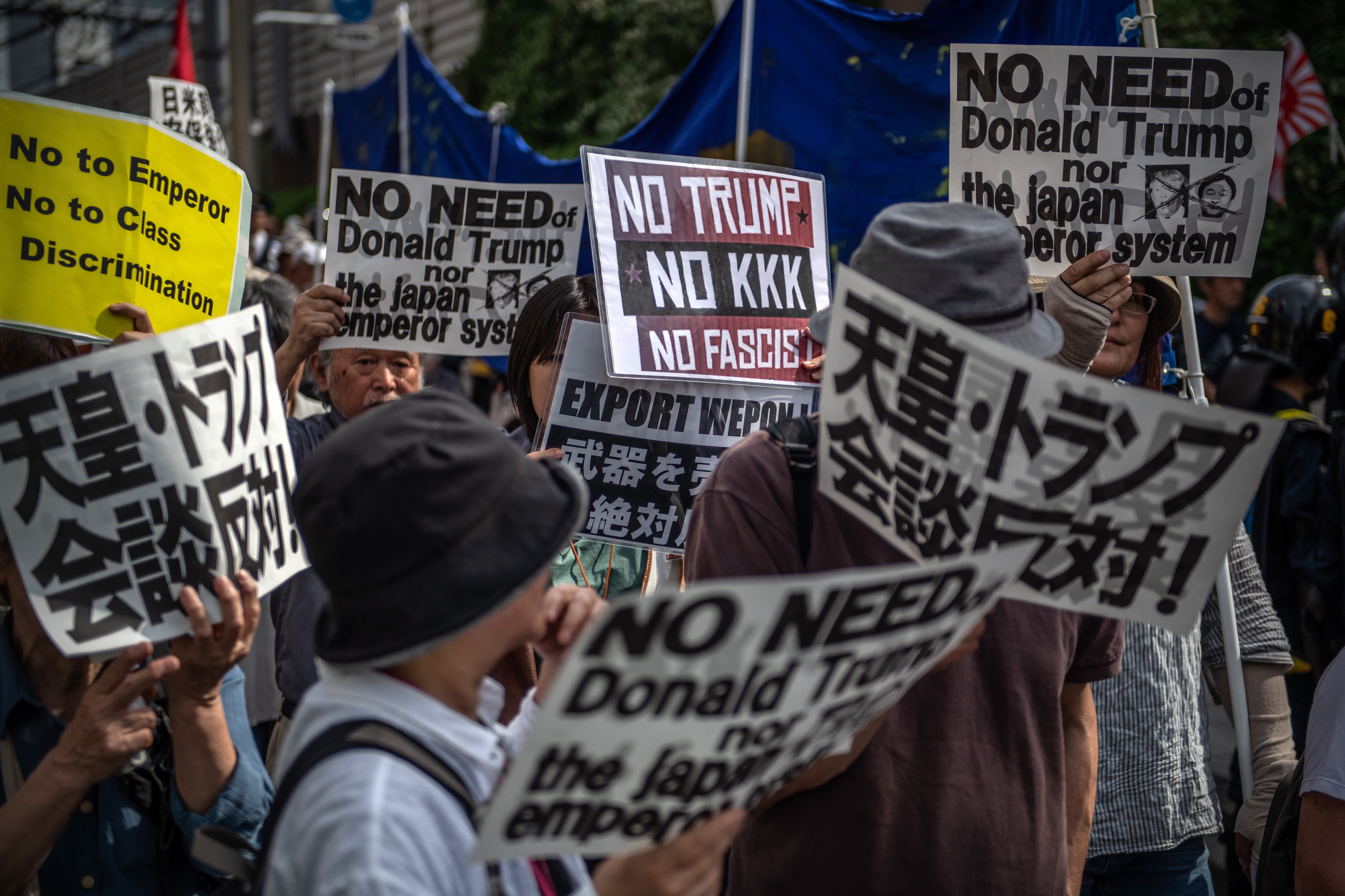 Demonstrators protest Japan's monarchy and Trump in Tokyo.