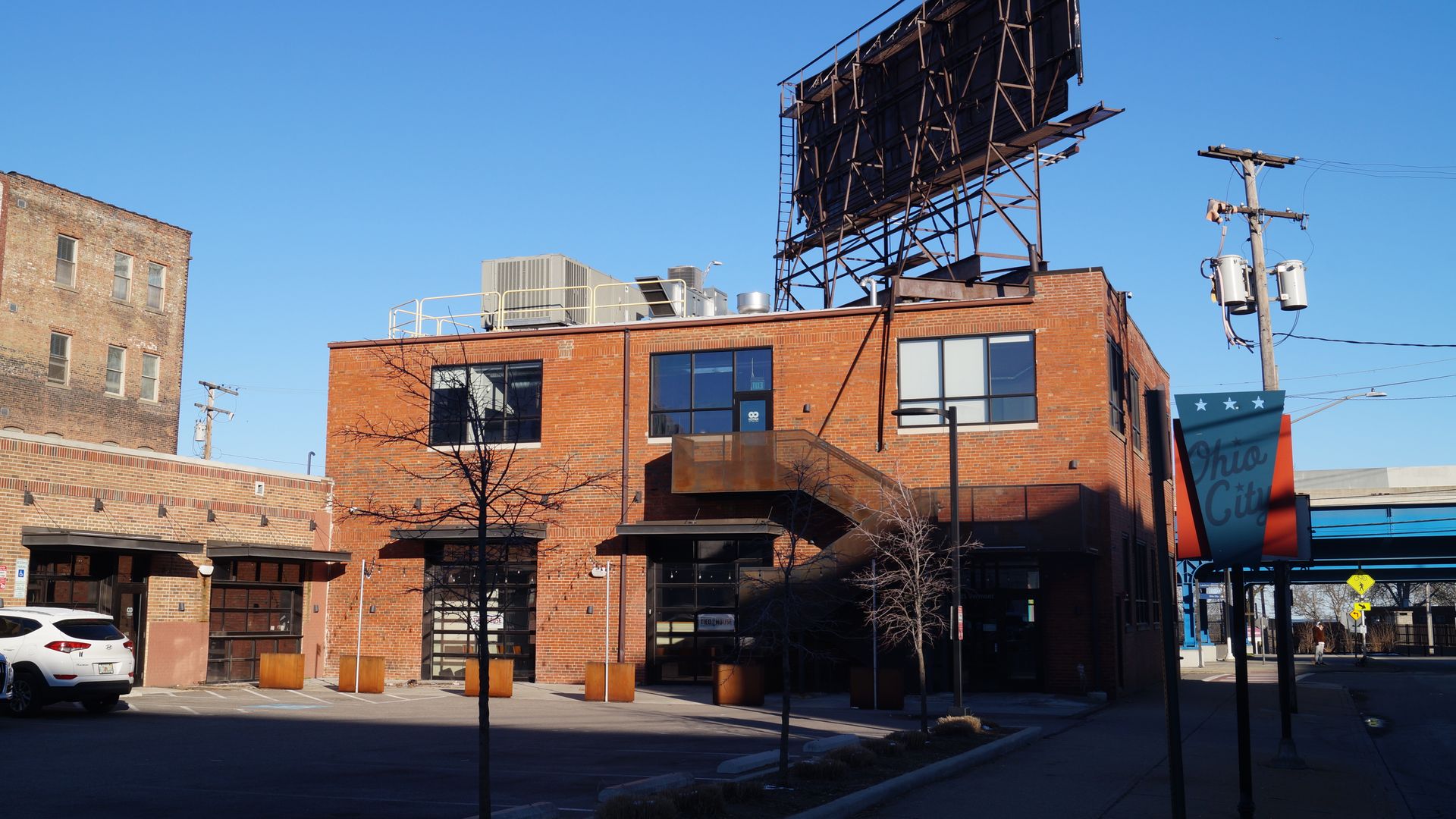 A two-story red brick building with blue sky behind