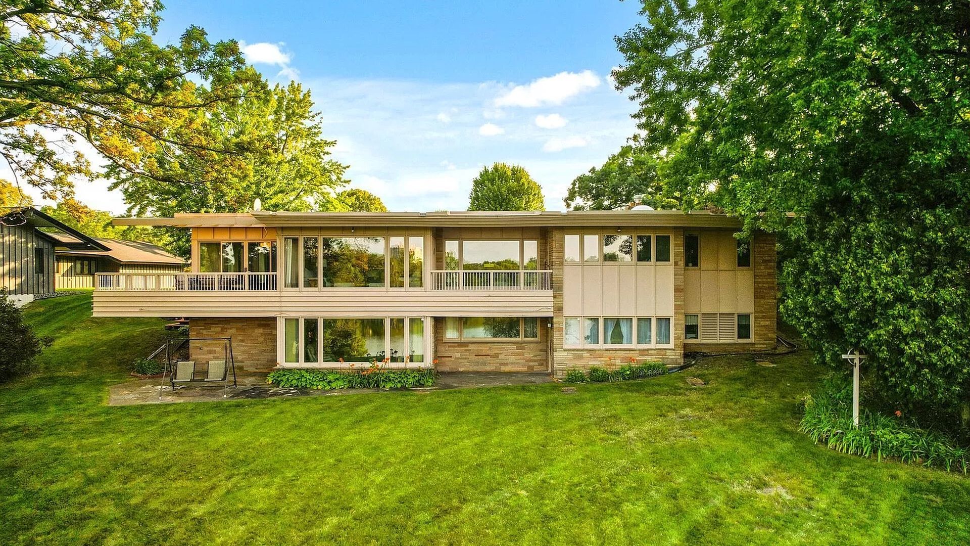 A photo of a house with large windows.
