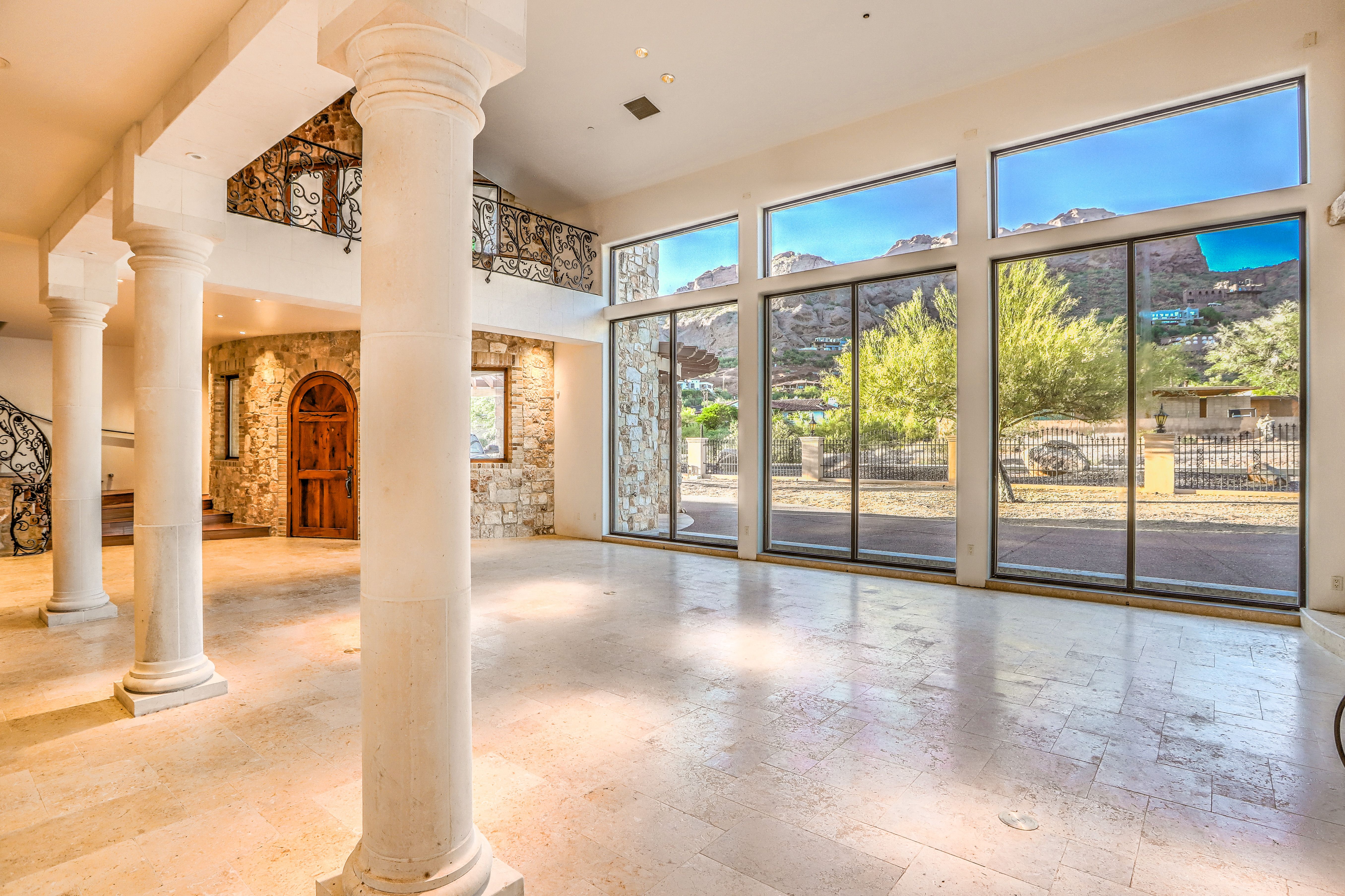 The inside of a mansion with mountains seen through the window. 