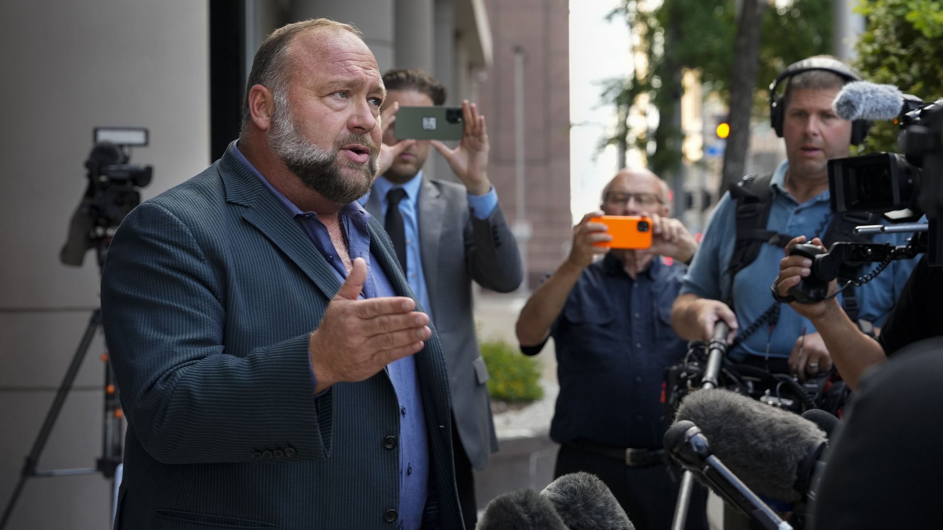 Right-wing conspiracy theorist Alex Jones speaks to the press before his bankruptcy hearing Friday, June 14, 2024 at Bob Casey Federal Courthouse in Houston. 
