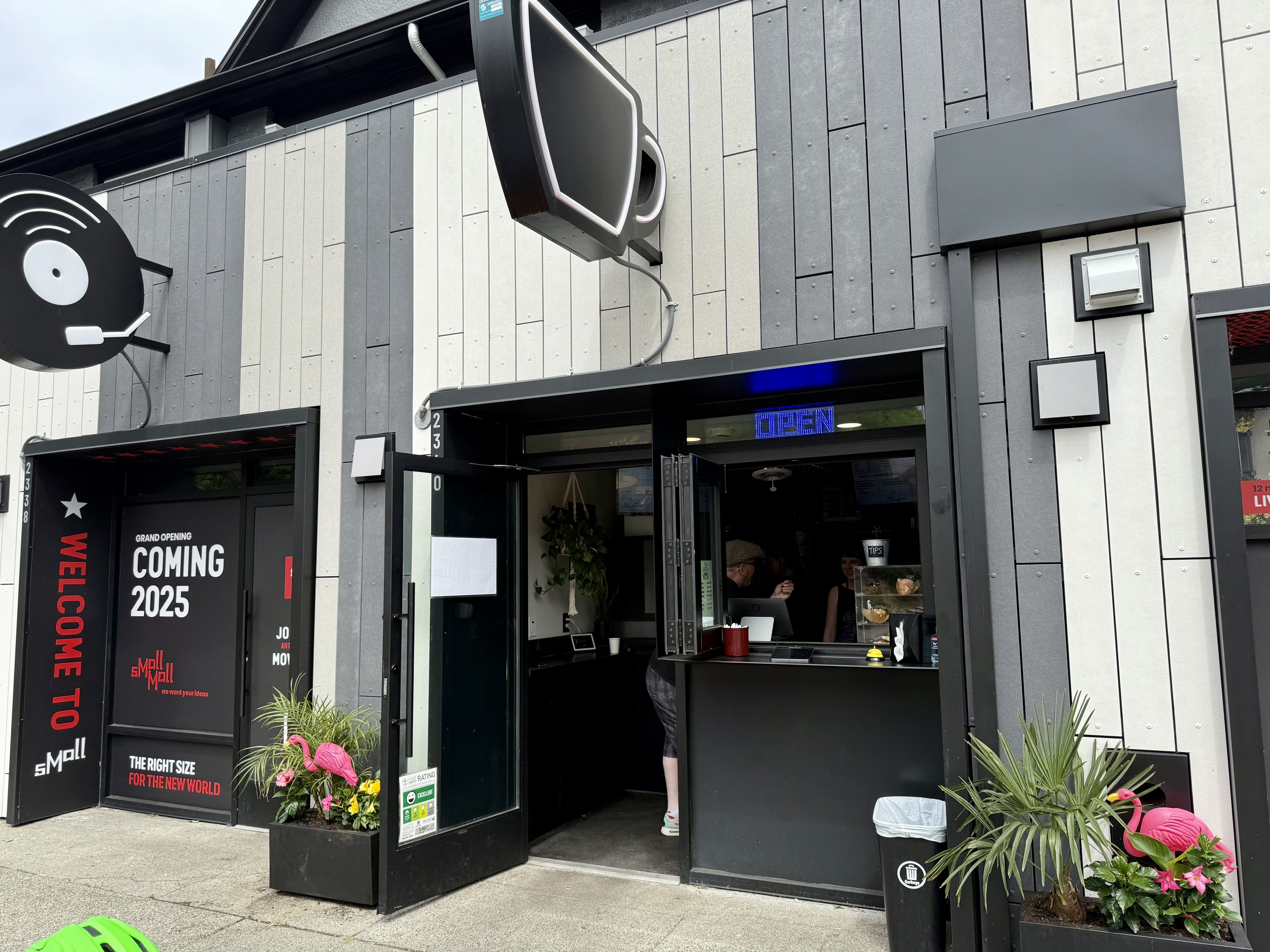 The front window of Shorehouse Coffee & Shaved Ice with a black coffee cup sign on top.