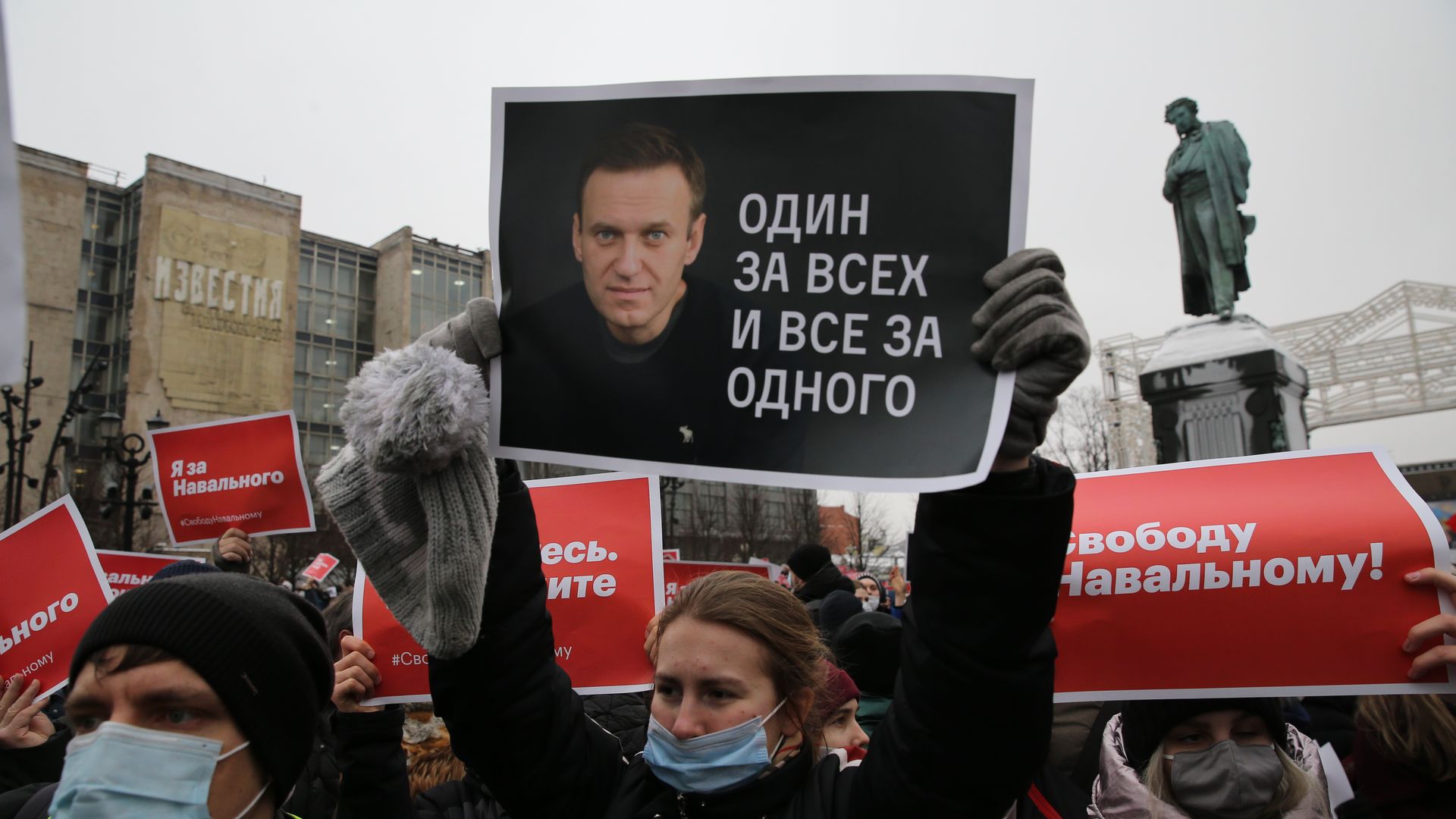 Protesters holding Navalny picture