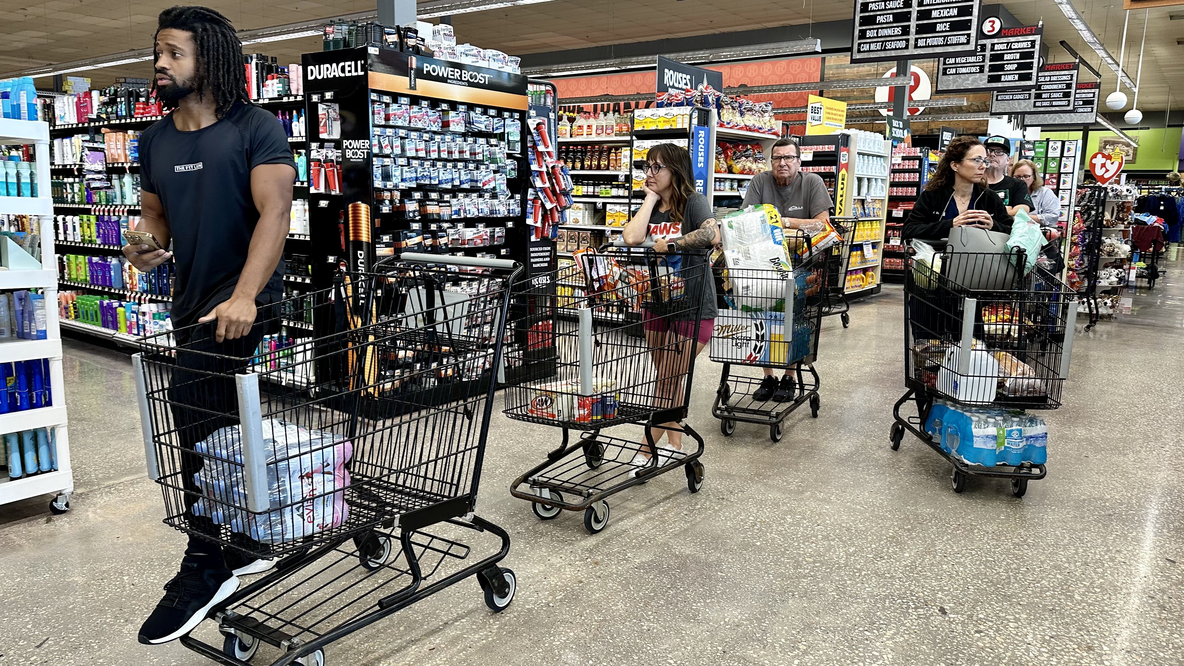 Photos shows people getting groceries.