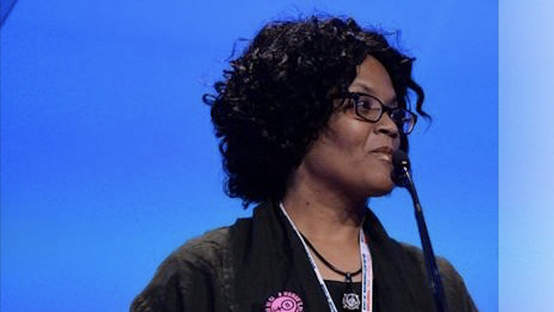 Side profile of Vonda McDaniel speaking at a podium