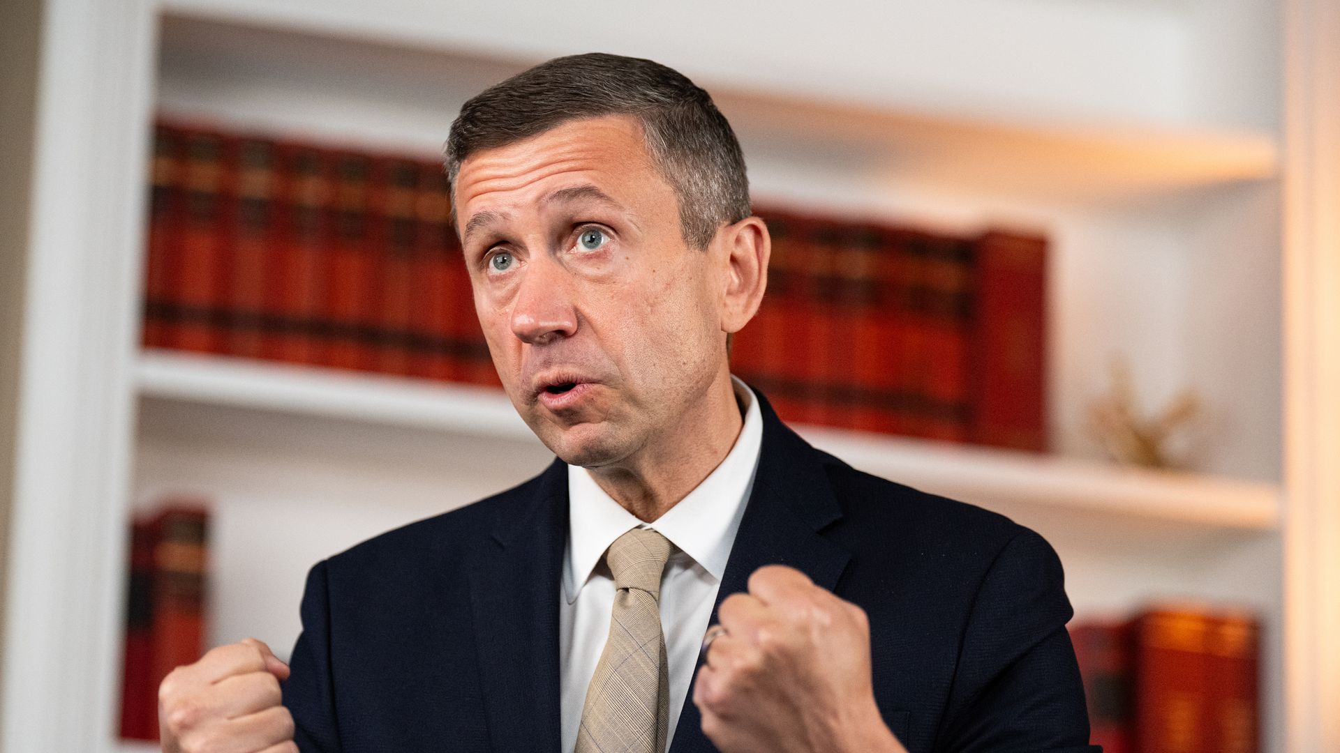 DNC chair Ken Martin closes his fists as he makes a point.