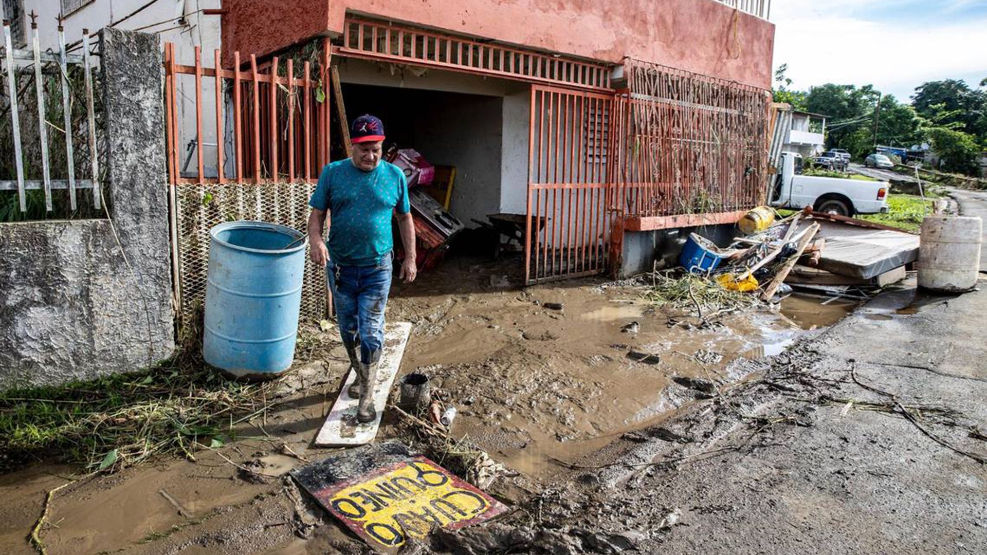 A man in Puerto Rico walks through mud after Hurricane Fiona devastated the island