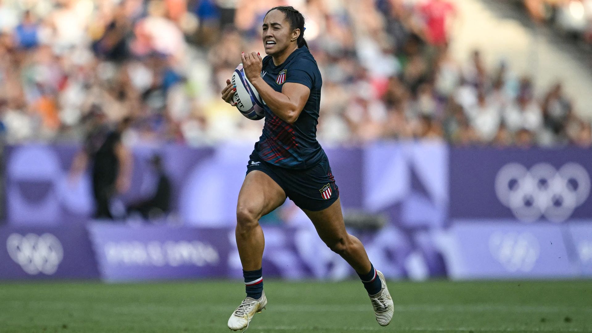 US' Alex Sedrick runs to score a try during the women's bronze medal rugby sevens match between USA and Australia during the Paris 2024 Olympic Games at the Stade de France in Saint-Denis on July 30, 2024. (Photo by CARL DE SOUZA / AFP) (Photo by CARL DE SOUZA/AFP via Getty Images)