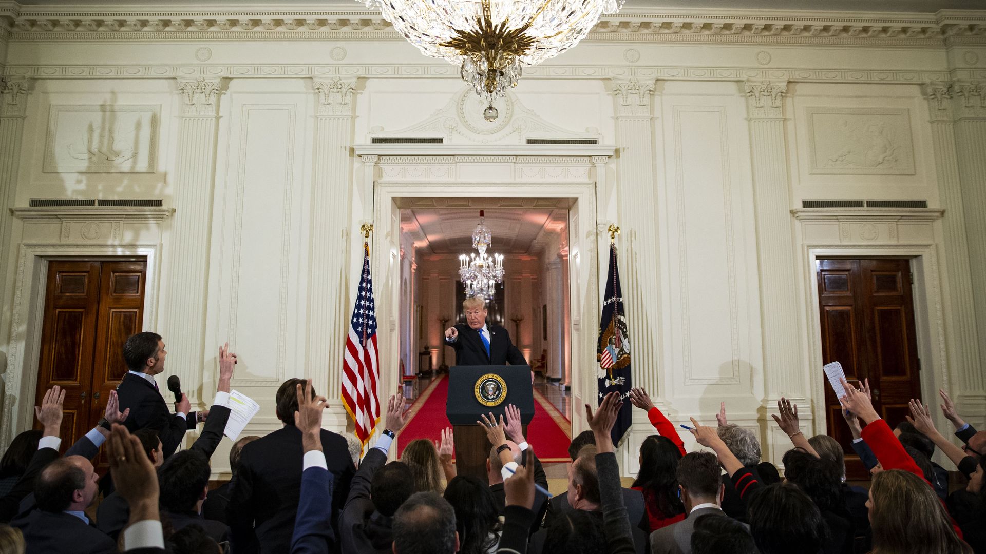 President Trump stands in front of the news media at a conference in the White House.