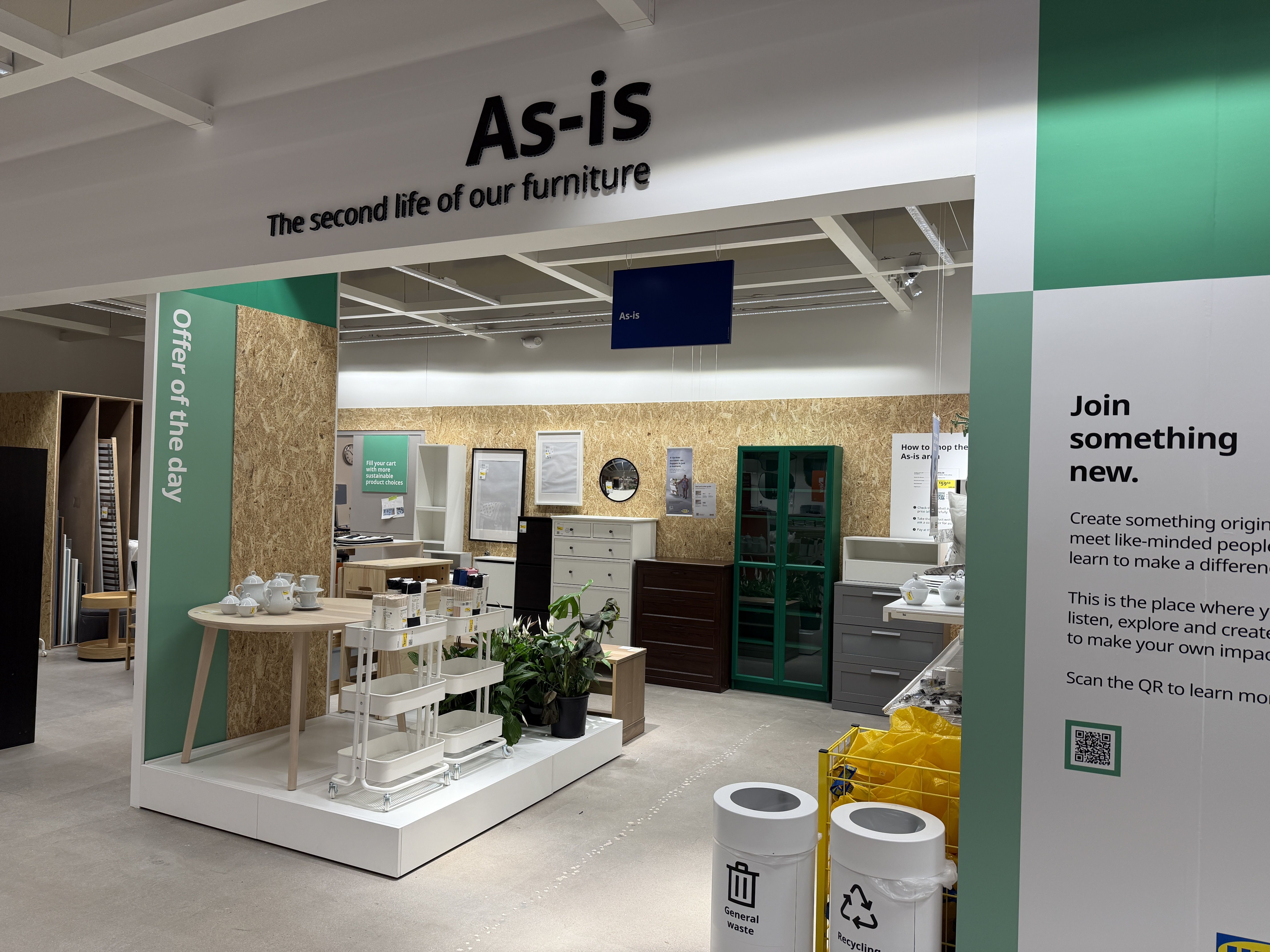 Showroom interior labeled "As-is: The second life of our furniture" with display tables, dressers, and shelves; green accents and a right panel that says "Join something new."