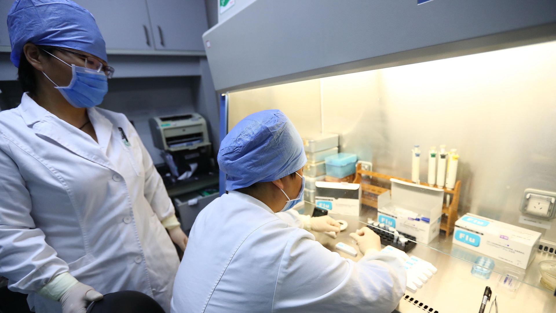 Two lab researchers test flu samples in China in 2018